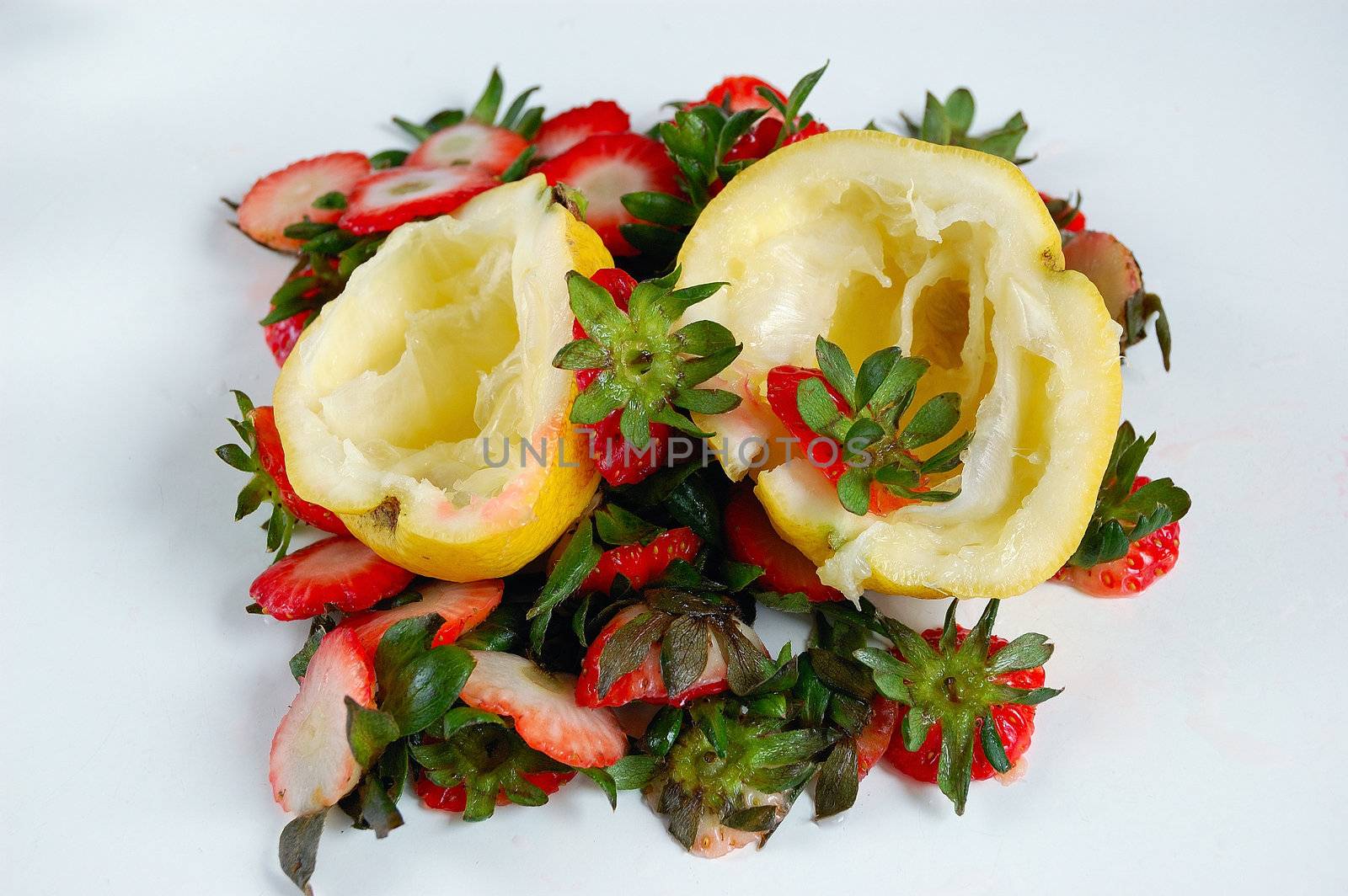 fruits (lemons and strawberries) scraps on a table