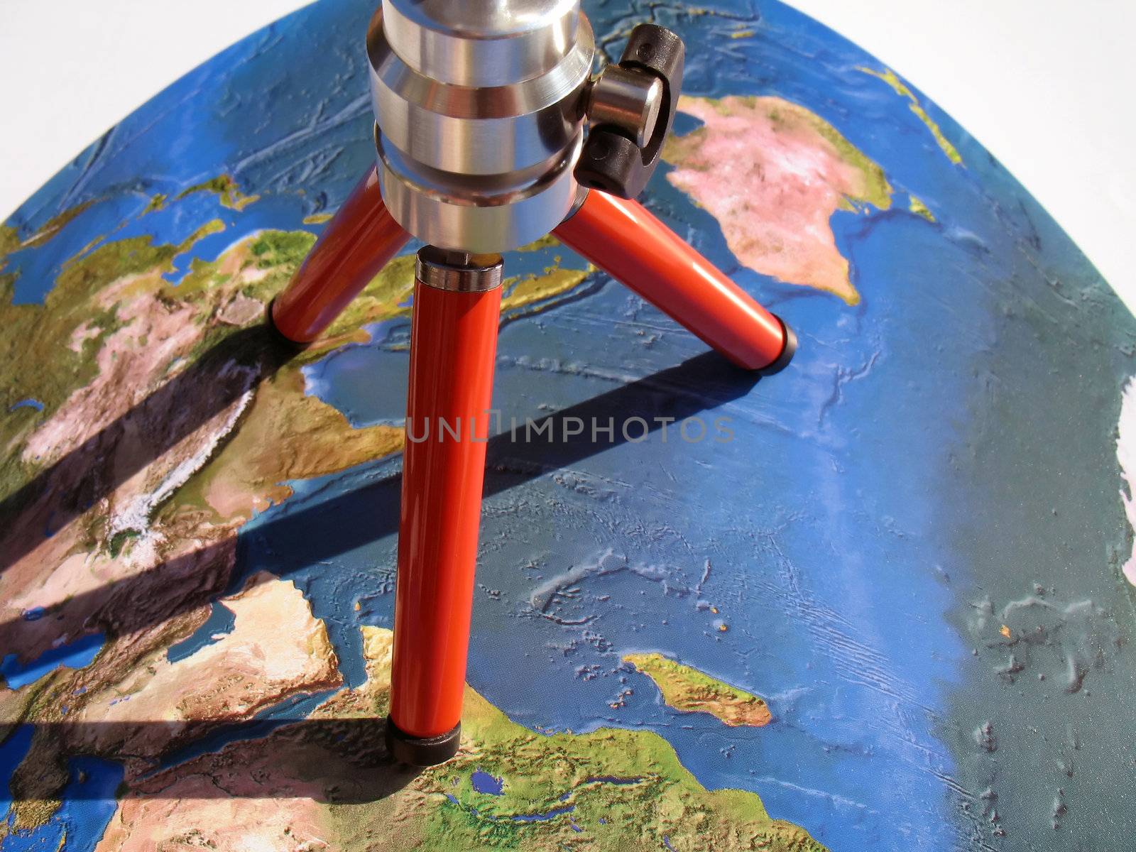 planning a tour around the world, atlas map and tripod