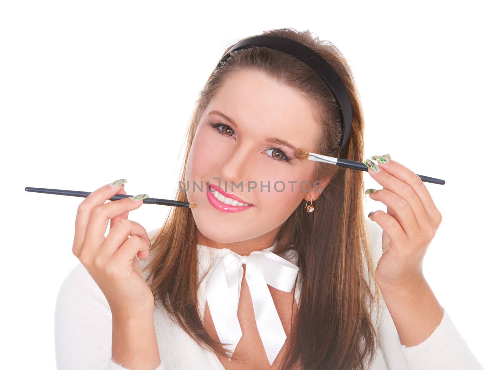 Beautiful girl applying makeup with two brushes isolated on white background
