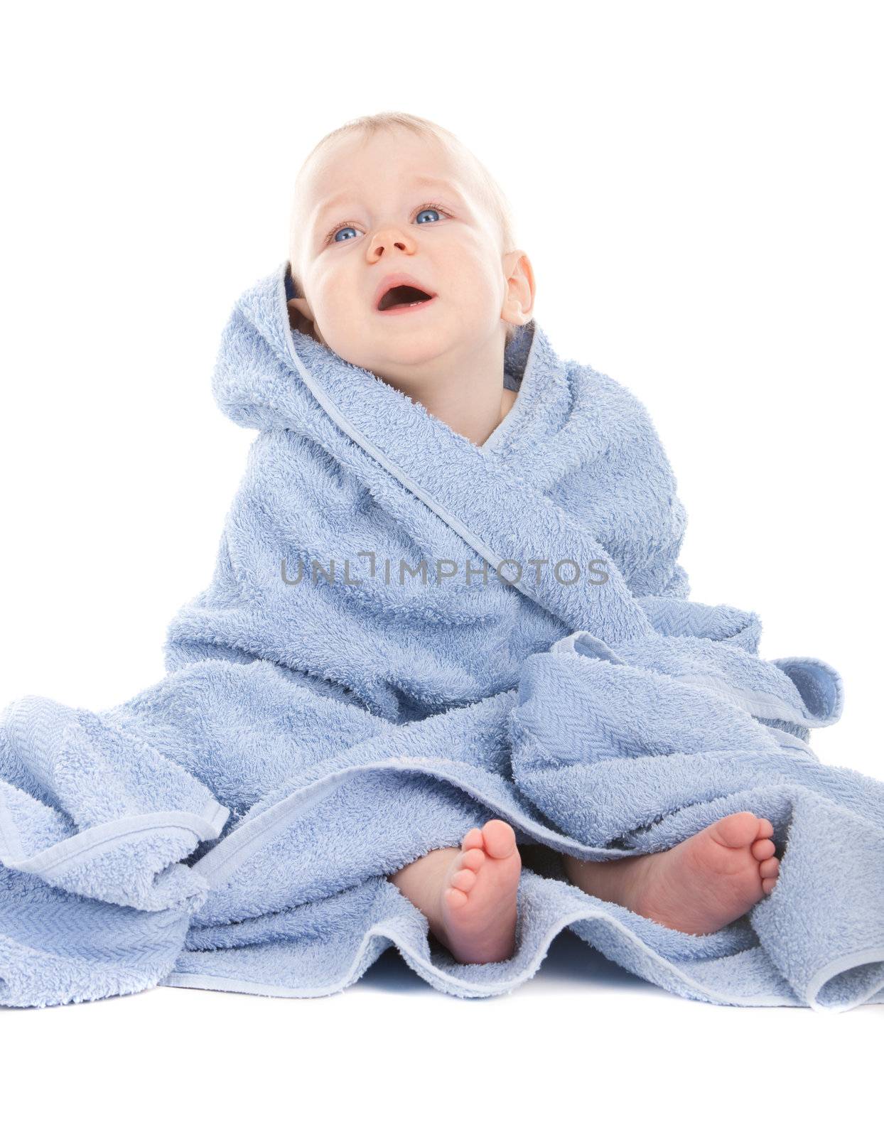 Crying baby sitting in a blue towel on white background