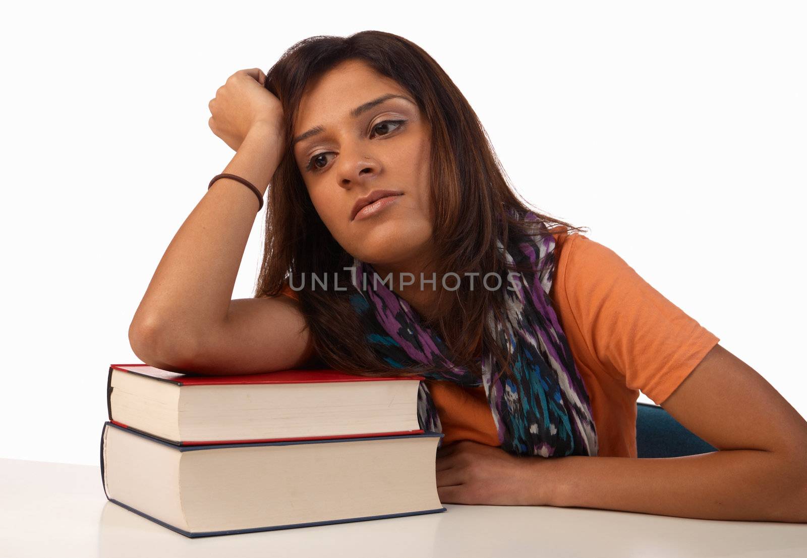 Middle eastern student in an uninterested attitude towards her books
