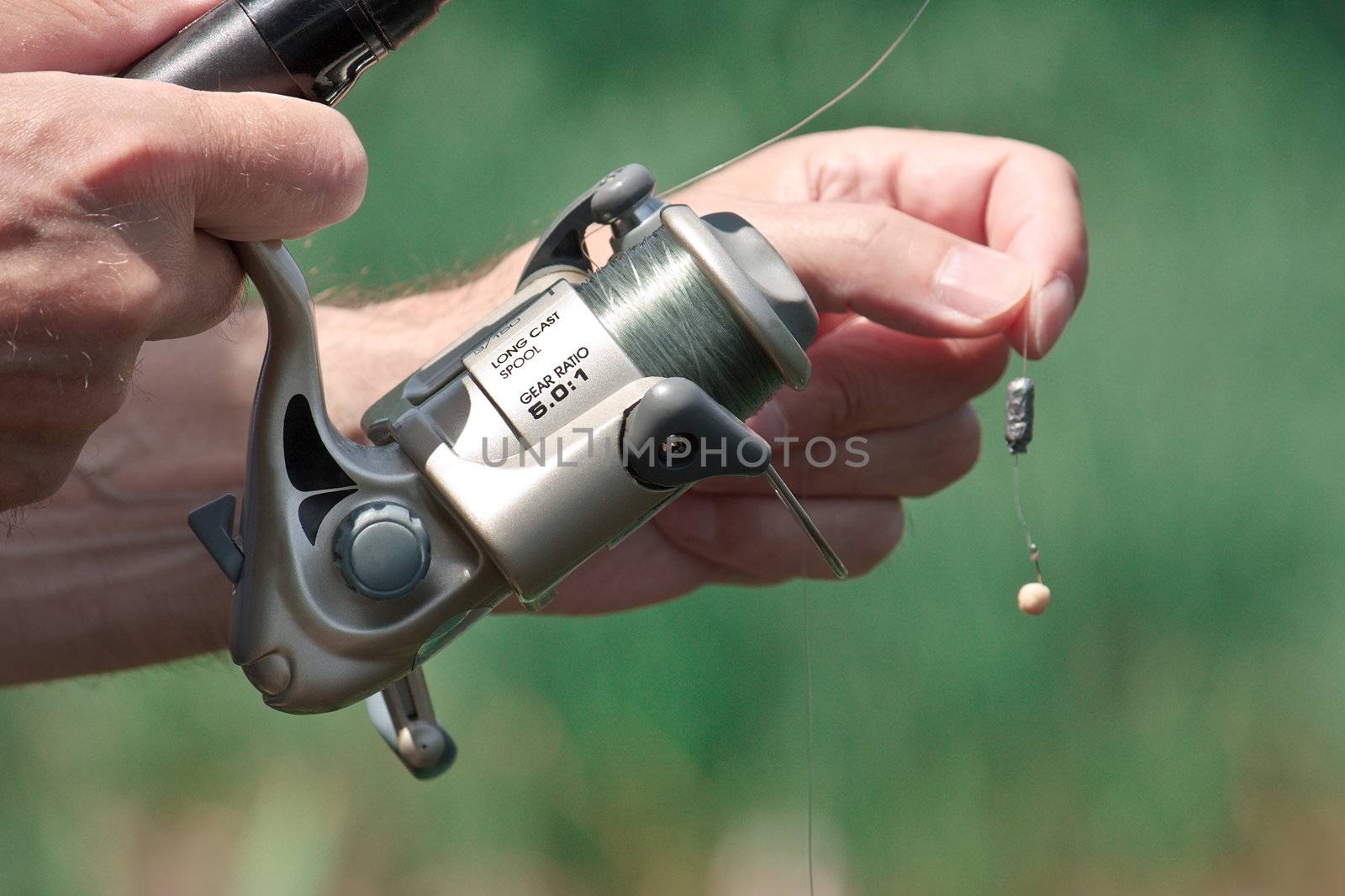 Closeup of a fisherman hand holding a fishing rod