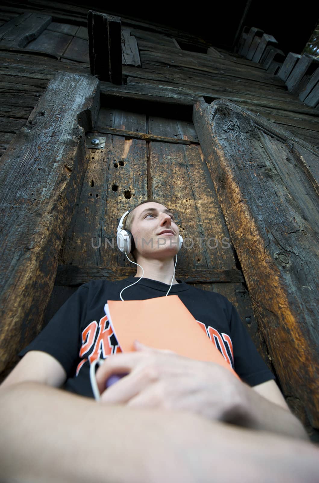 Man listening to the music in a park with white headphones