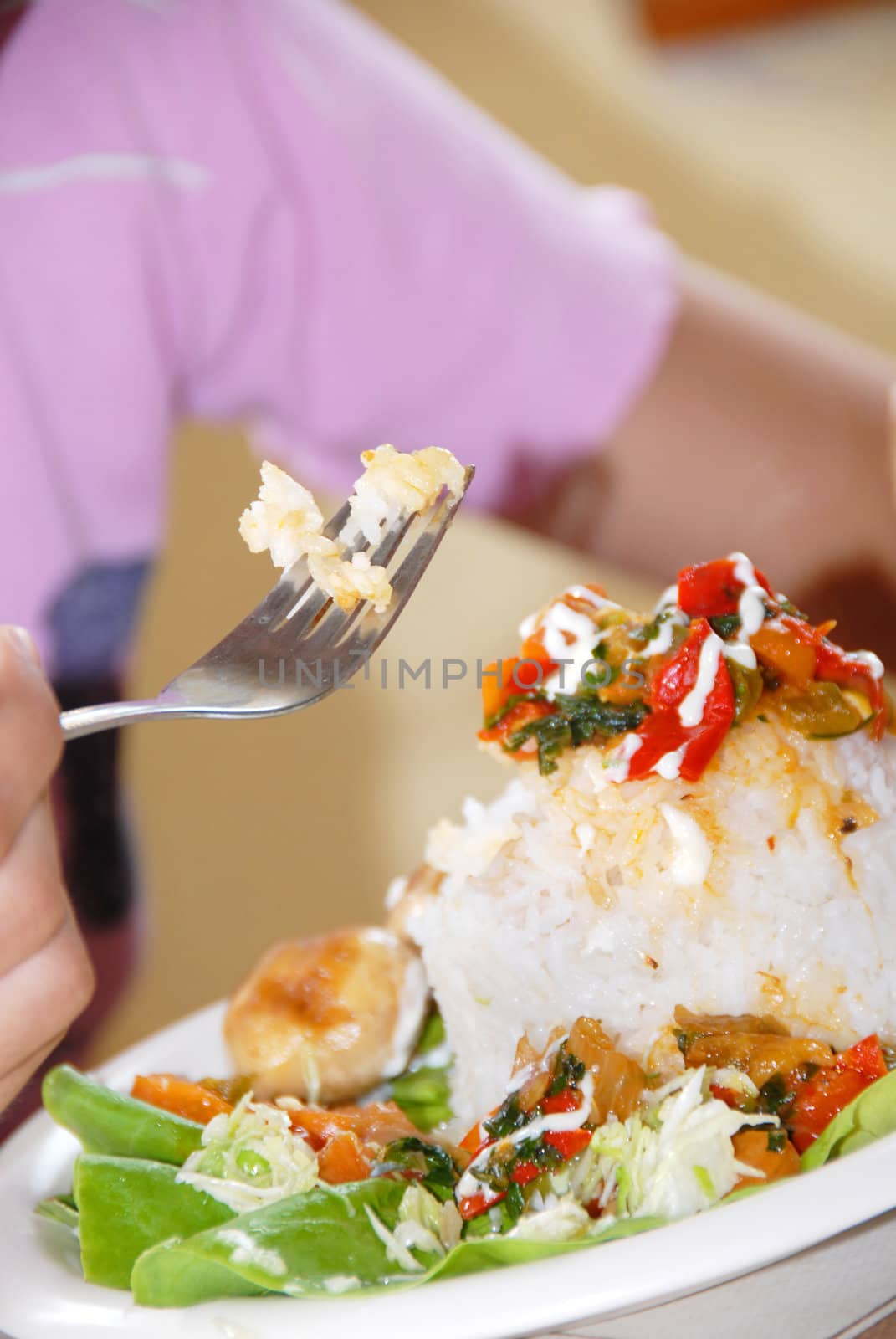 rice and vegetables served on plate, rice on fork