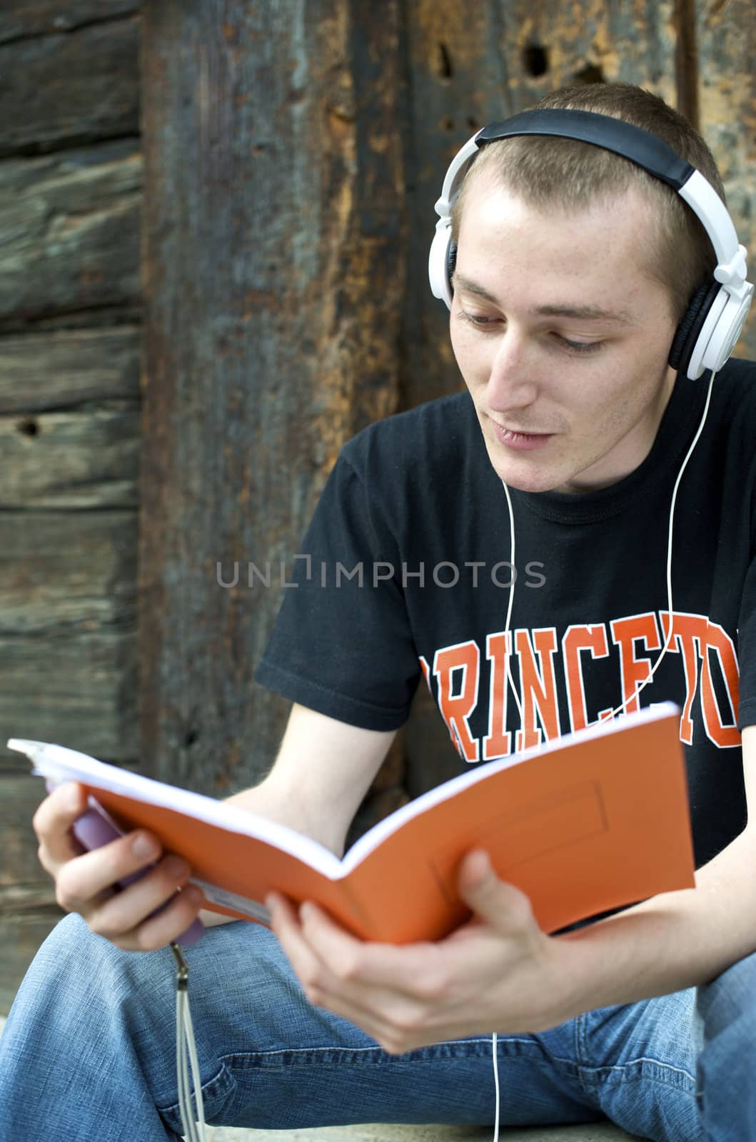 Man listening to the music in a park with white headphones