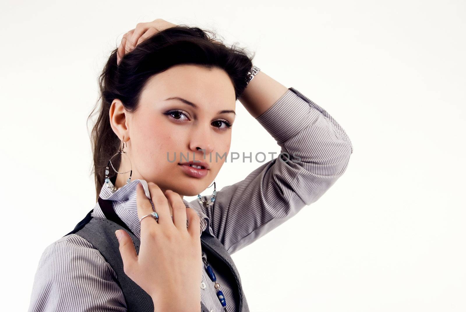 Portrait of a young  beautiful  fashionable brunette  holding the collar  of  her shirt