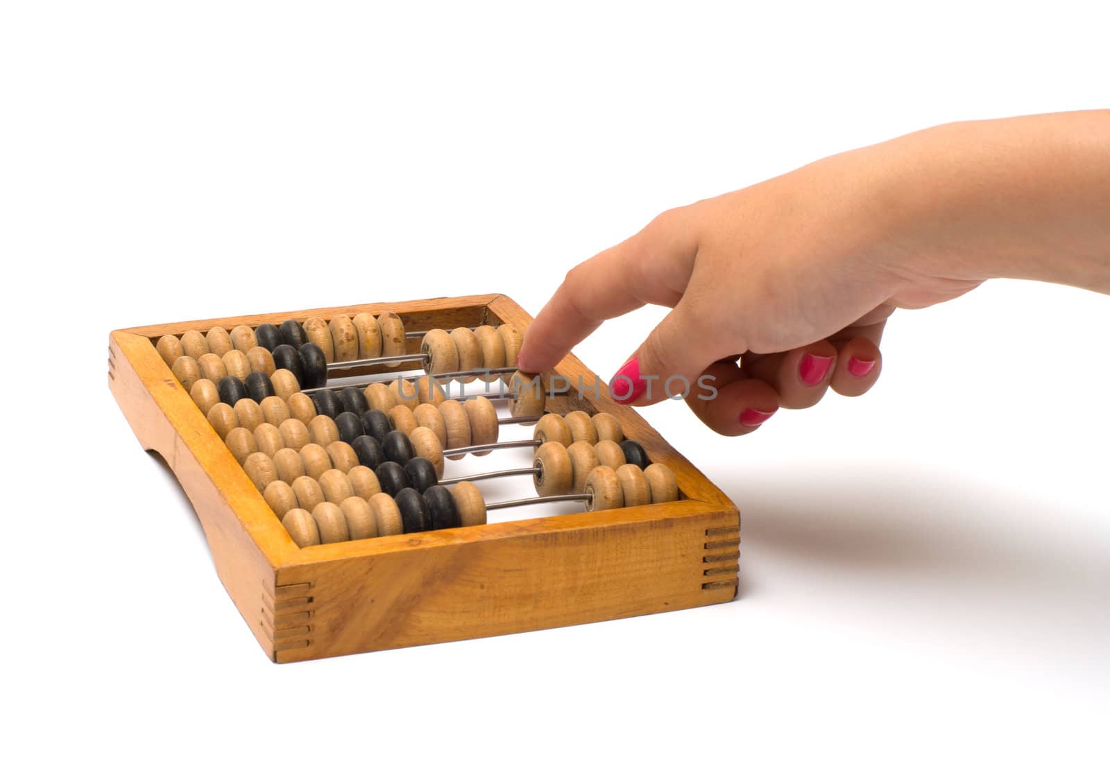 Female hand on old wooden an abacus it is isolated on a white background.