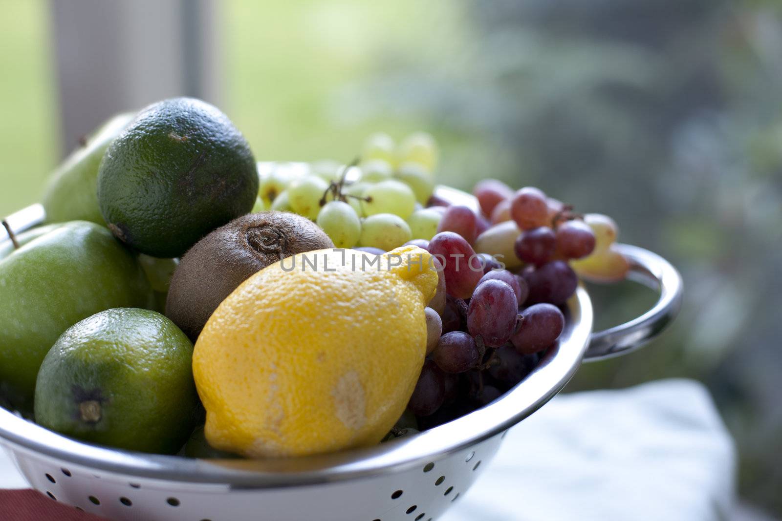 Colander of fresh fruit with shallow depth of field.