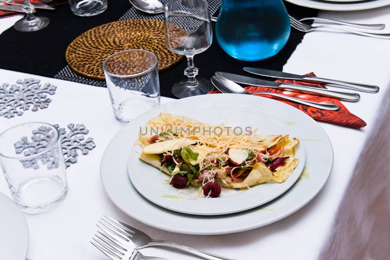 Close up to plate with entree on set table by Colette