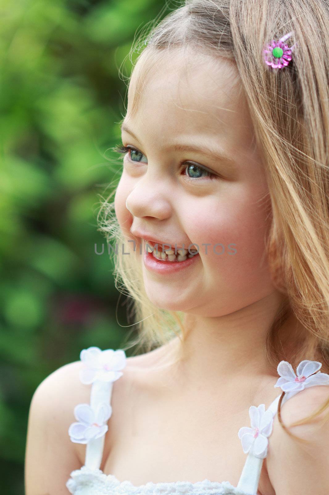 Portrait of a laughing little girl in the sunlight.