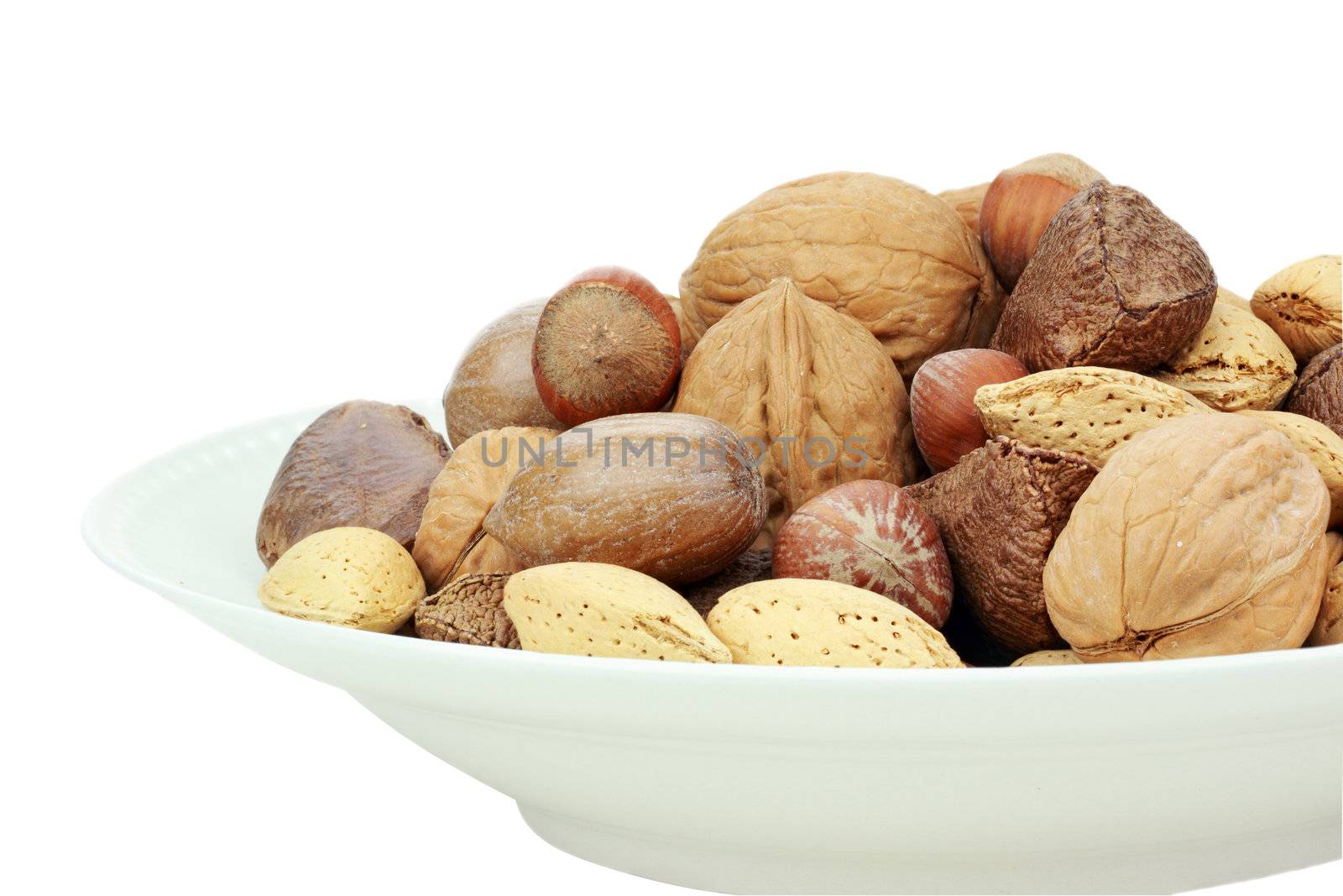 A variety of whole mixed nuts in the shell against a white background. Clipping path included.