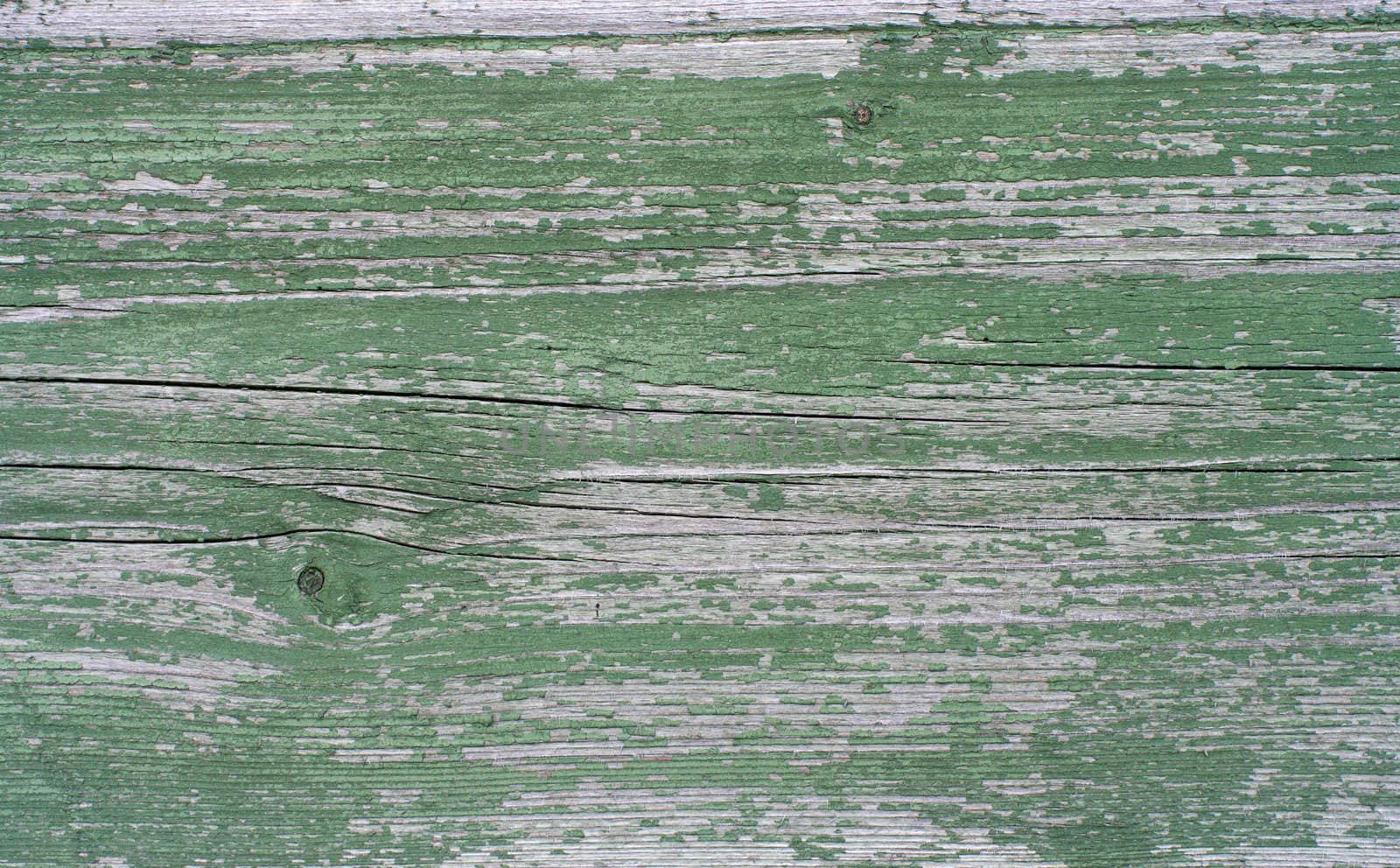 The old board with peeling green paint.