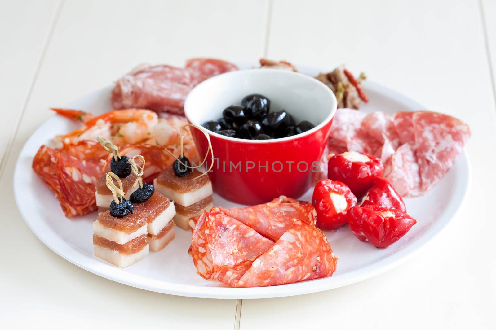 Plate of antipasti with chorizo, cheese, poppers, pepper, salami, and olives