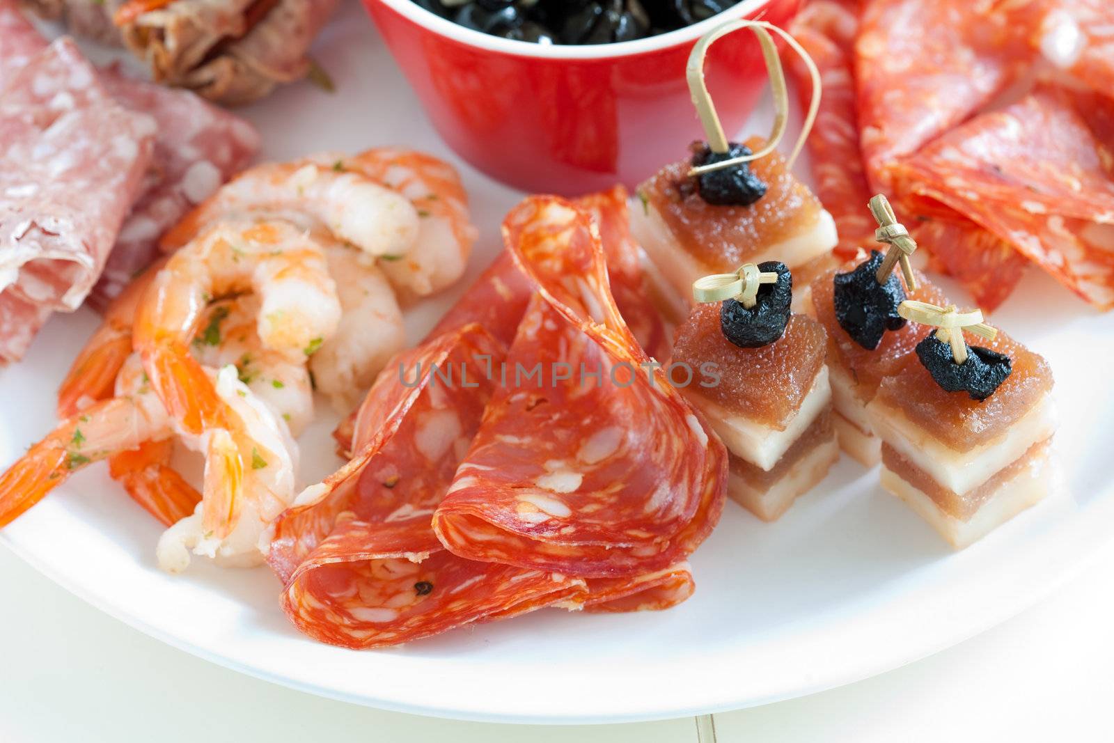 Delicious plate with antipasti snacks such as chorizo and shrimps