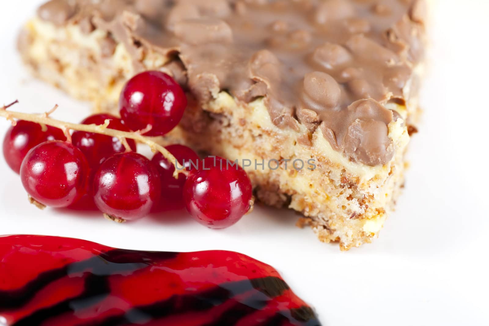 Close up of fresh red currants and slice of chocolate almond cake