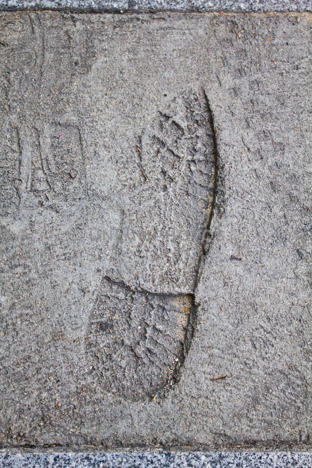 Footprint in footpath cement by lavoview