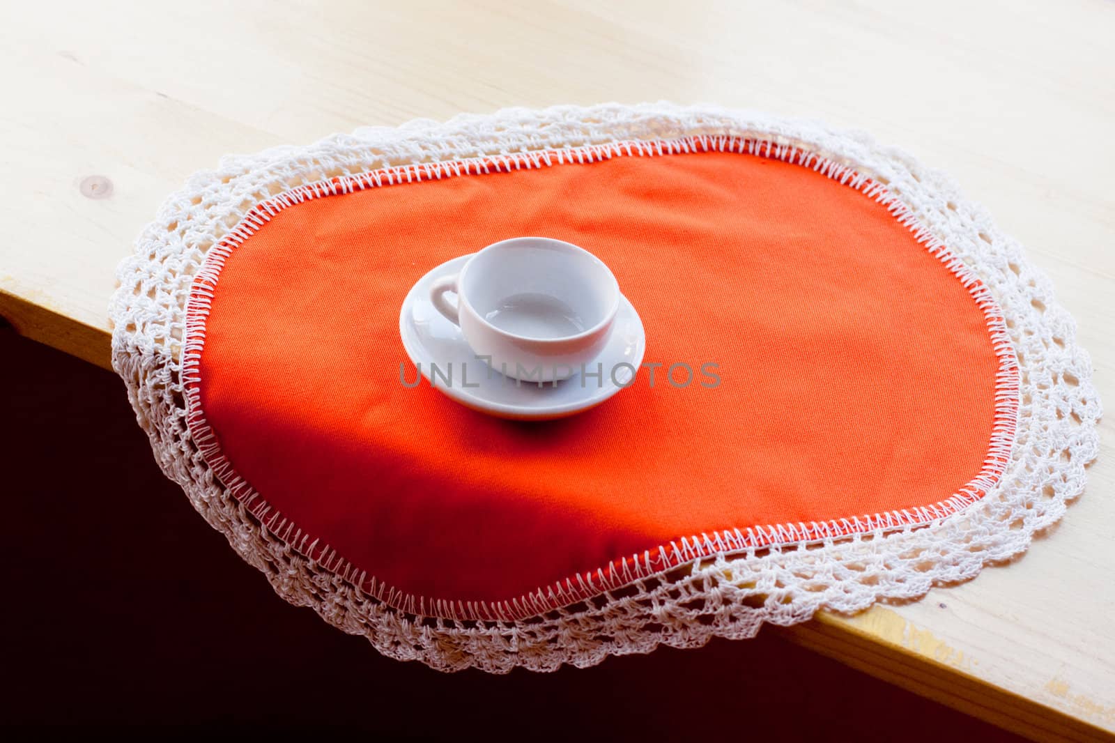 A coffee cup on an orange napkin
