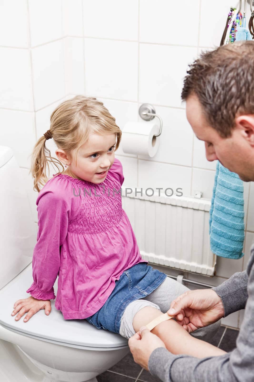 Father and Daughter Band-Aid in the bathroom