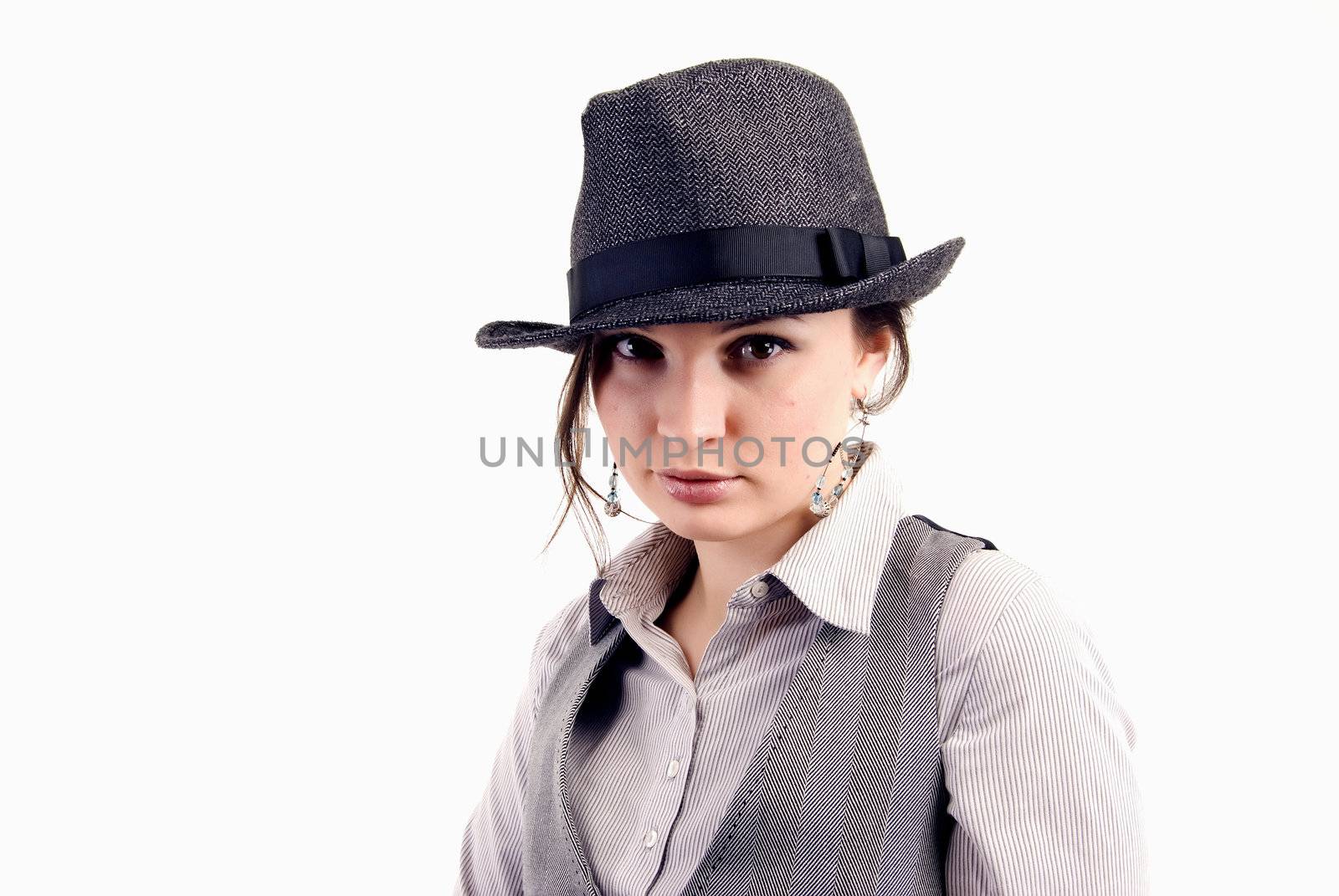 Portrait of a young beautiful seductive brunette in the hat