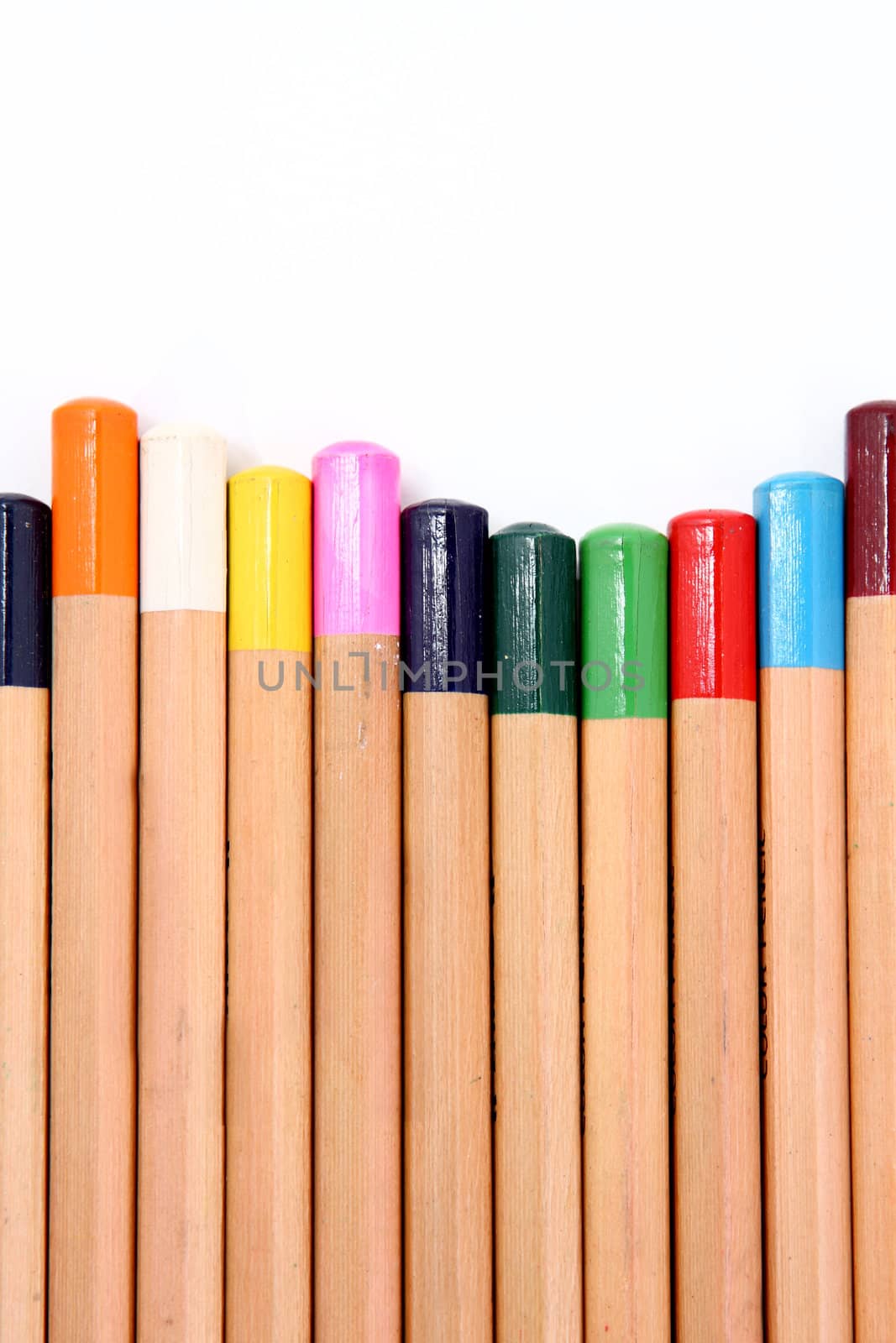 Colour pencils isolated on white background close up .