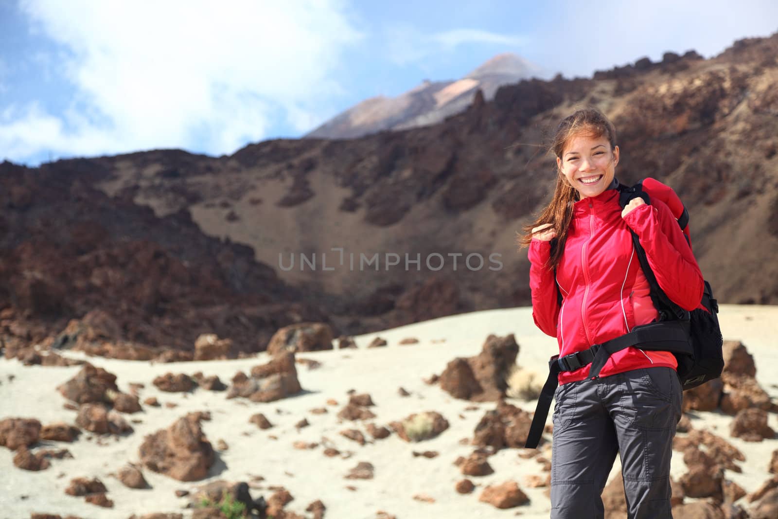 Hiking. Female hiker on Tenerife. From Teide National Park with the peak of Teide in the background. Canary Islands.
