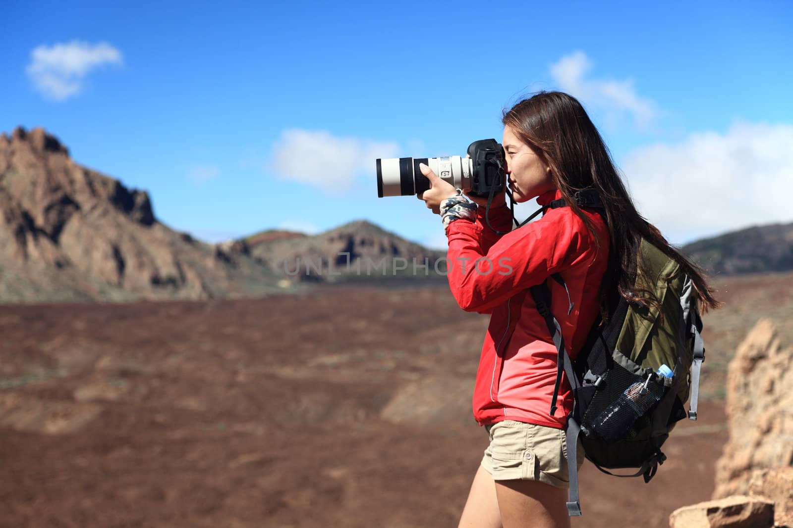 Nature Photographer taking pictures outdoors during hiking trip on Teide, Tenerife, Canary Islands. 