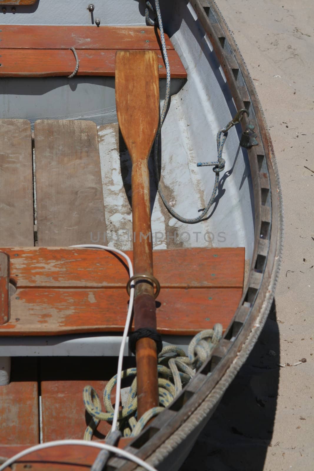 An old row boat on a white sand beach