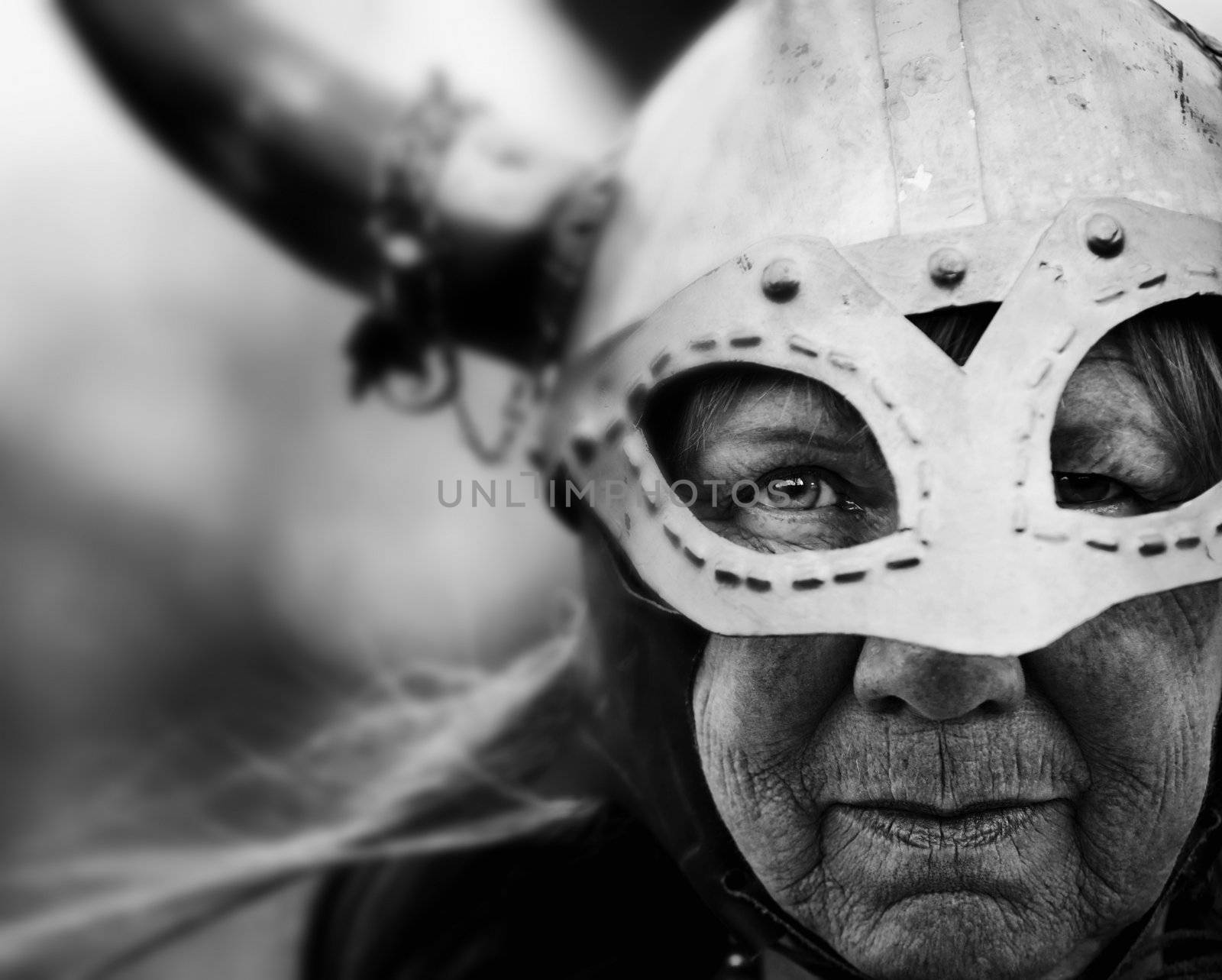 Closeup portrait of Viking woman in helmet with horns