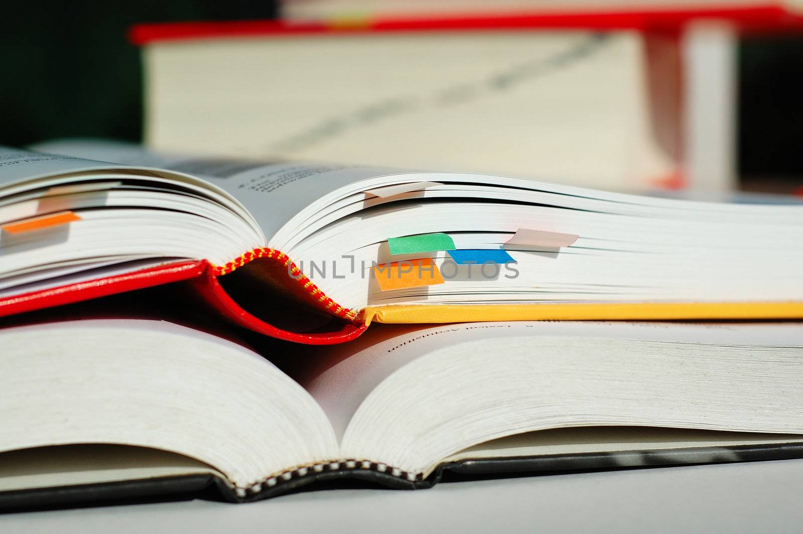 Two books are opened and piled together