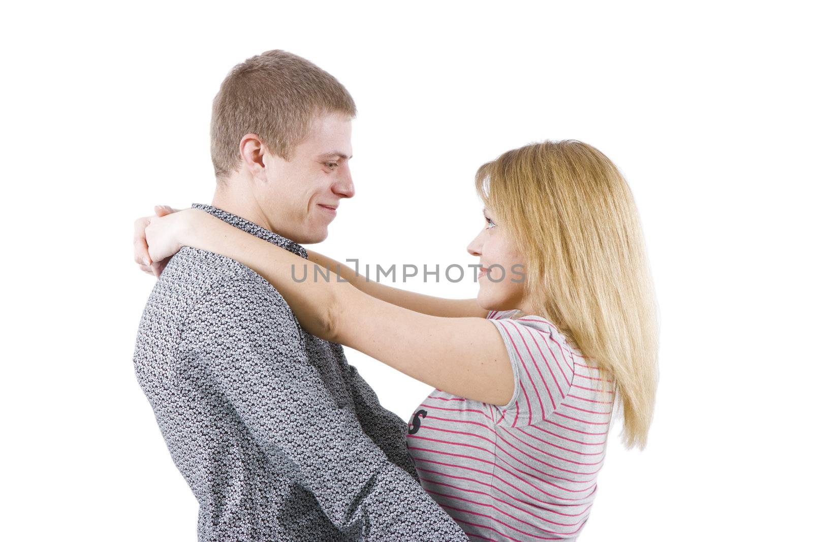 on a white background happy young couple hugging
