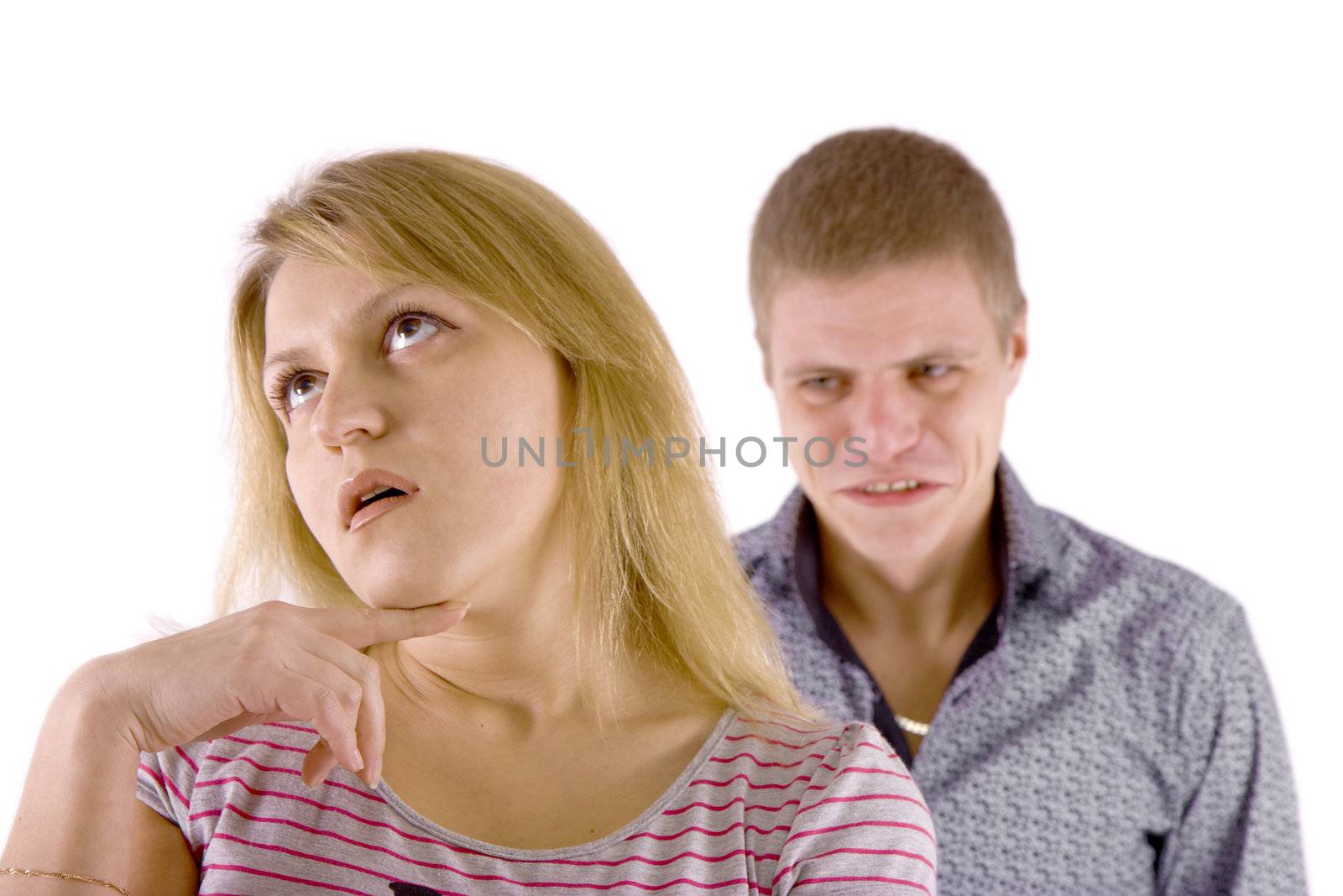 Young couple quarrel. A man in a rage, the woman is indifferent.
