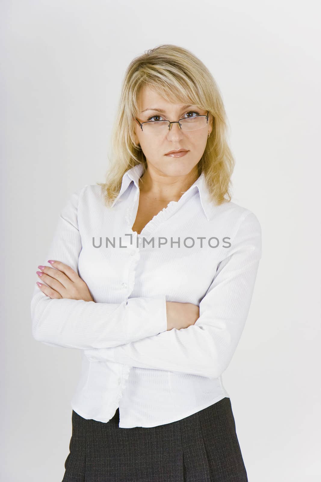 serious business woman in glasses and a white blouse
