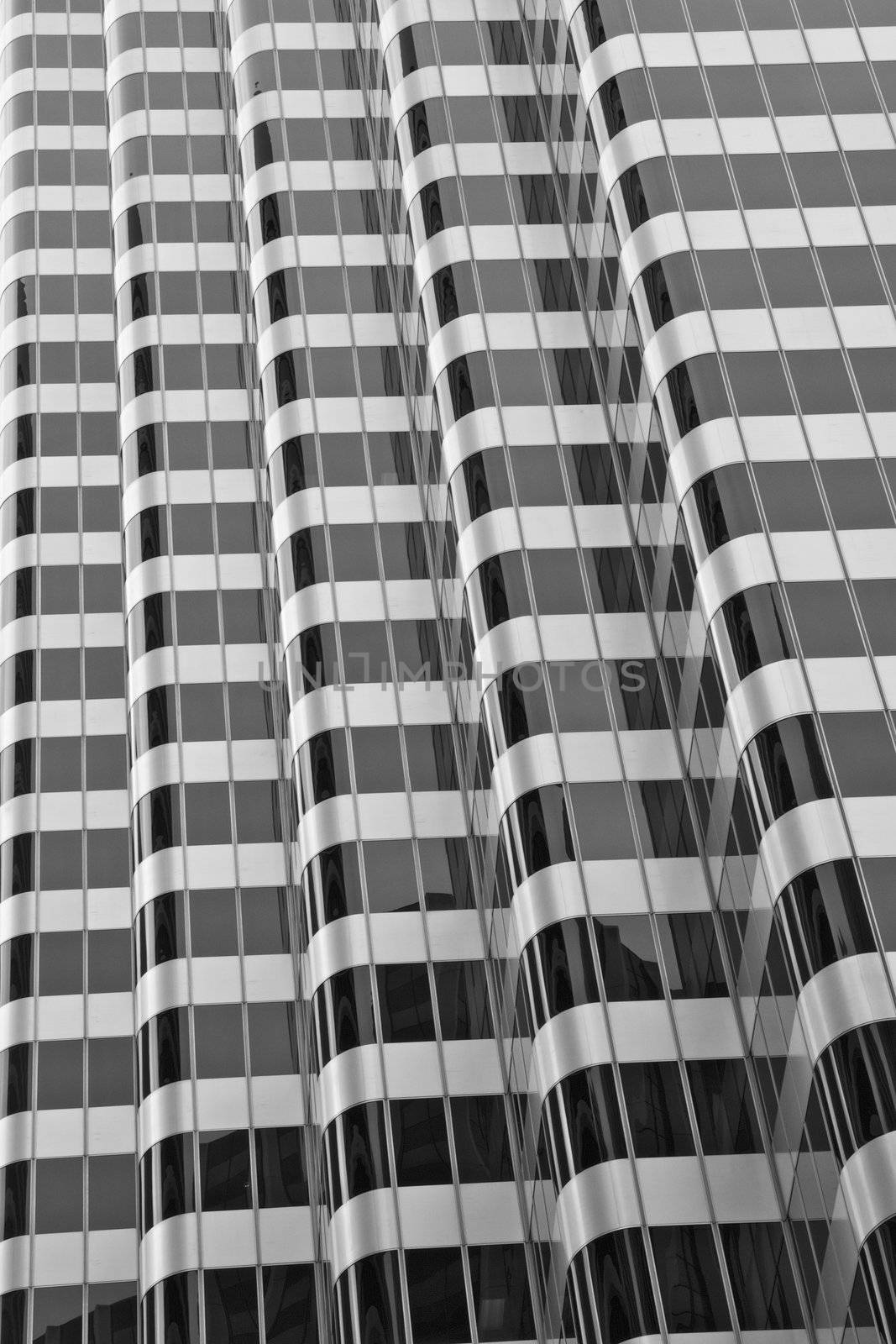 Black and White Abstract view of a modern windowed round cornered office building