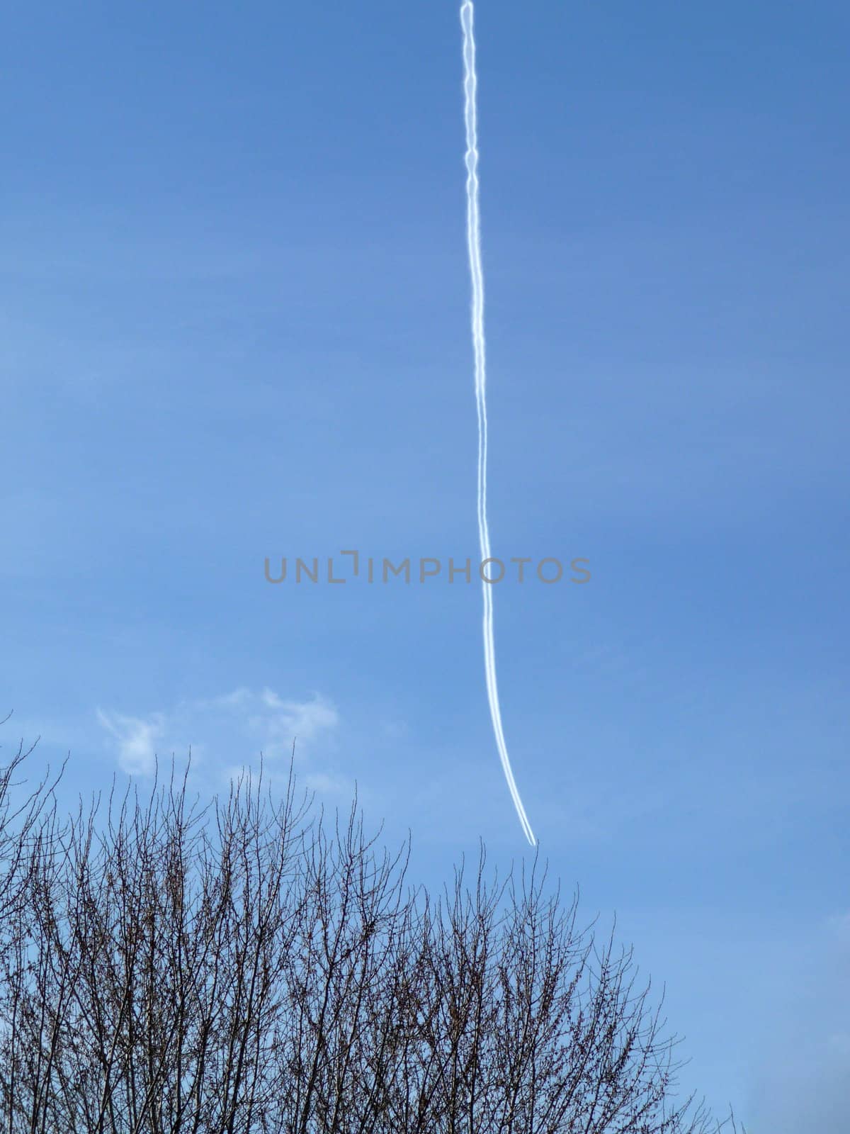 
A hard to see airplane and its chemtrail high in the blue sky.
