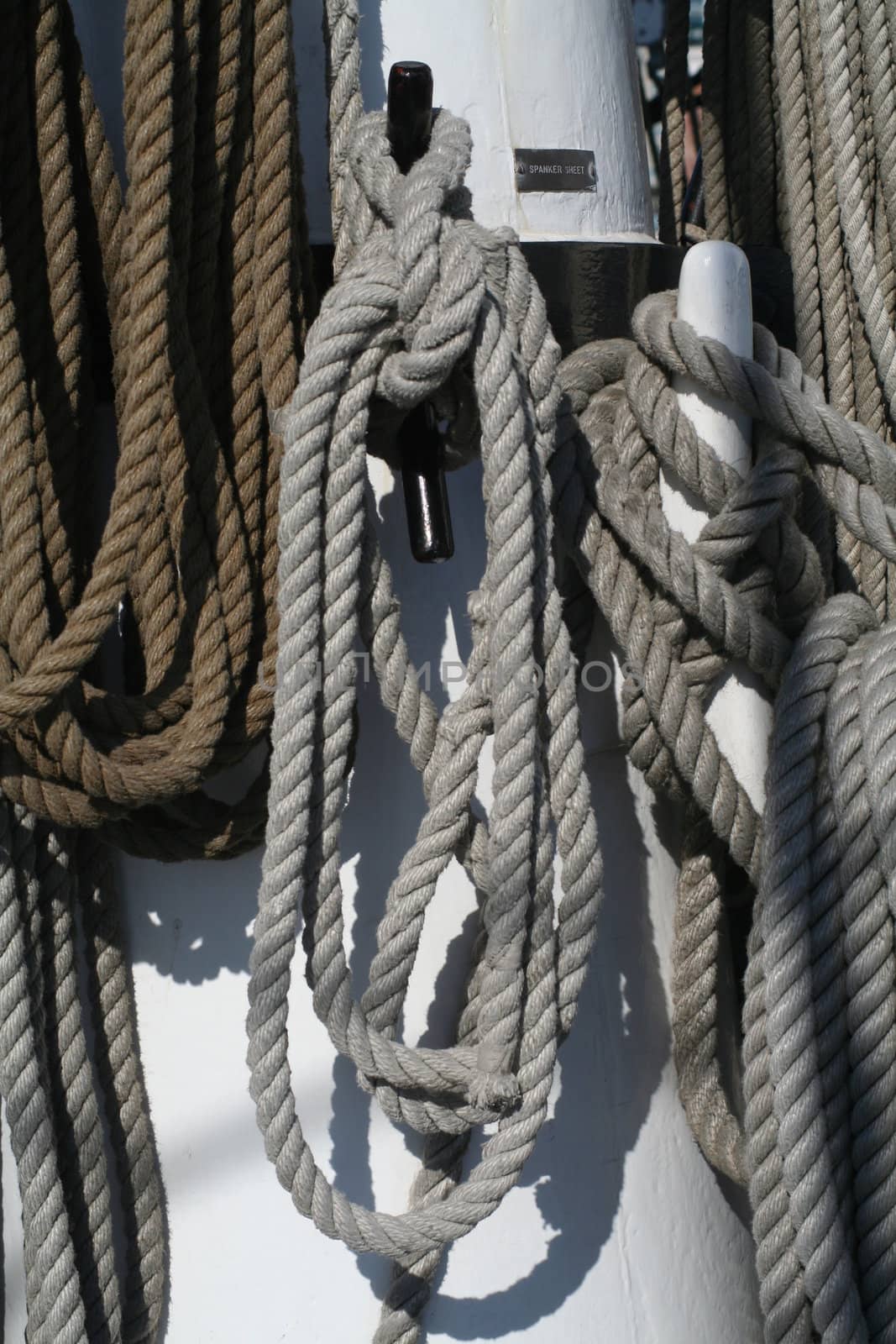 Line on a tall ship coiled and hanging on deck.