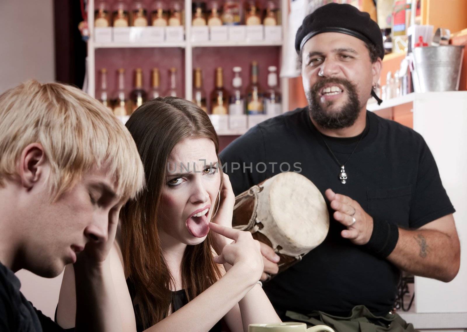 Couple in coffee house listening to a bad percusionist