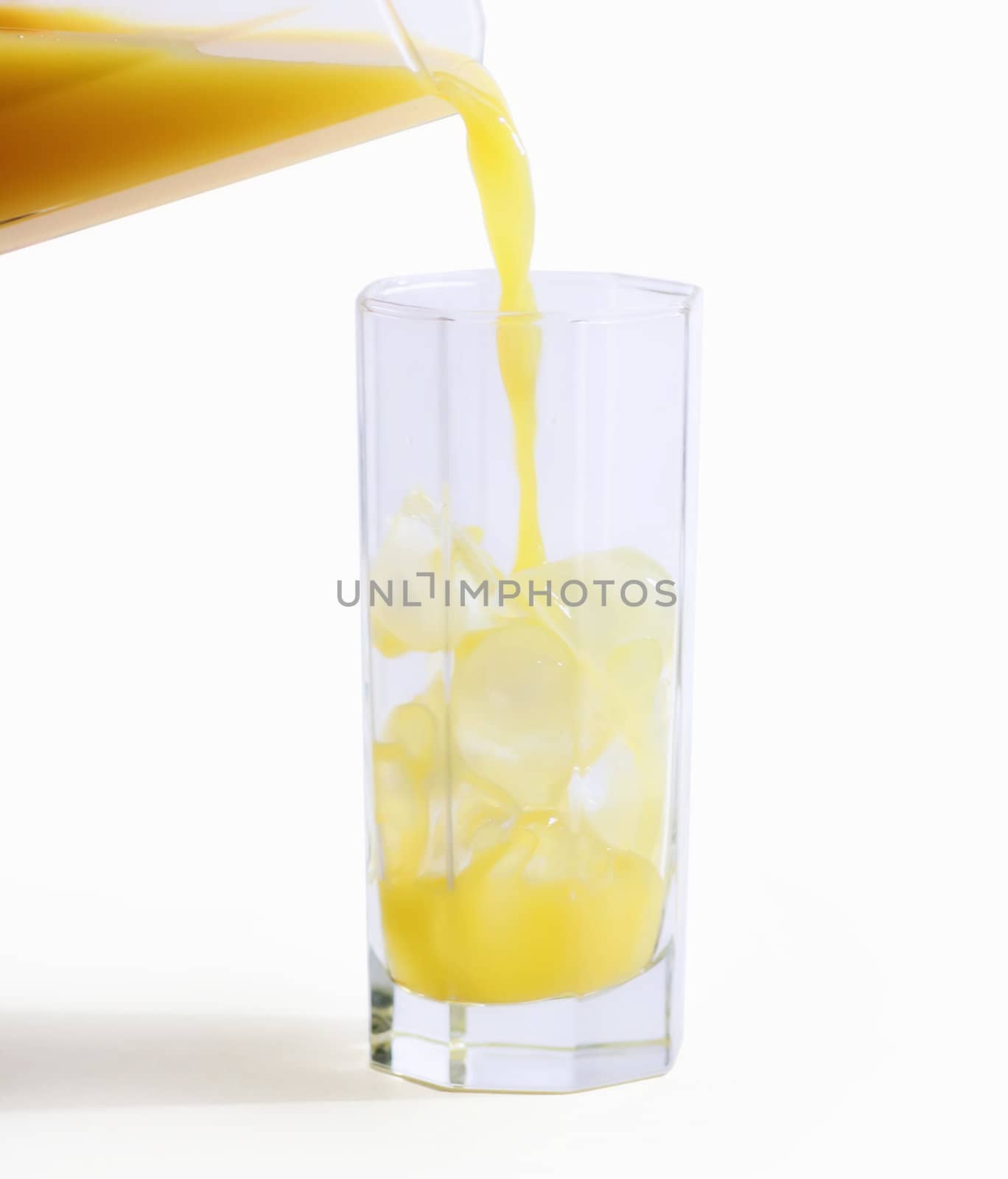 orange juce pouring in a glass on white background  with space for your text  - hand made clipping path included