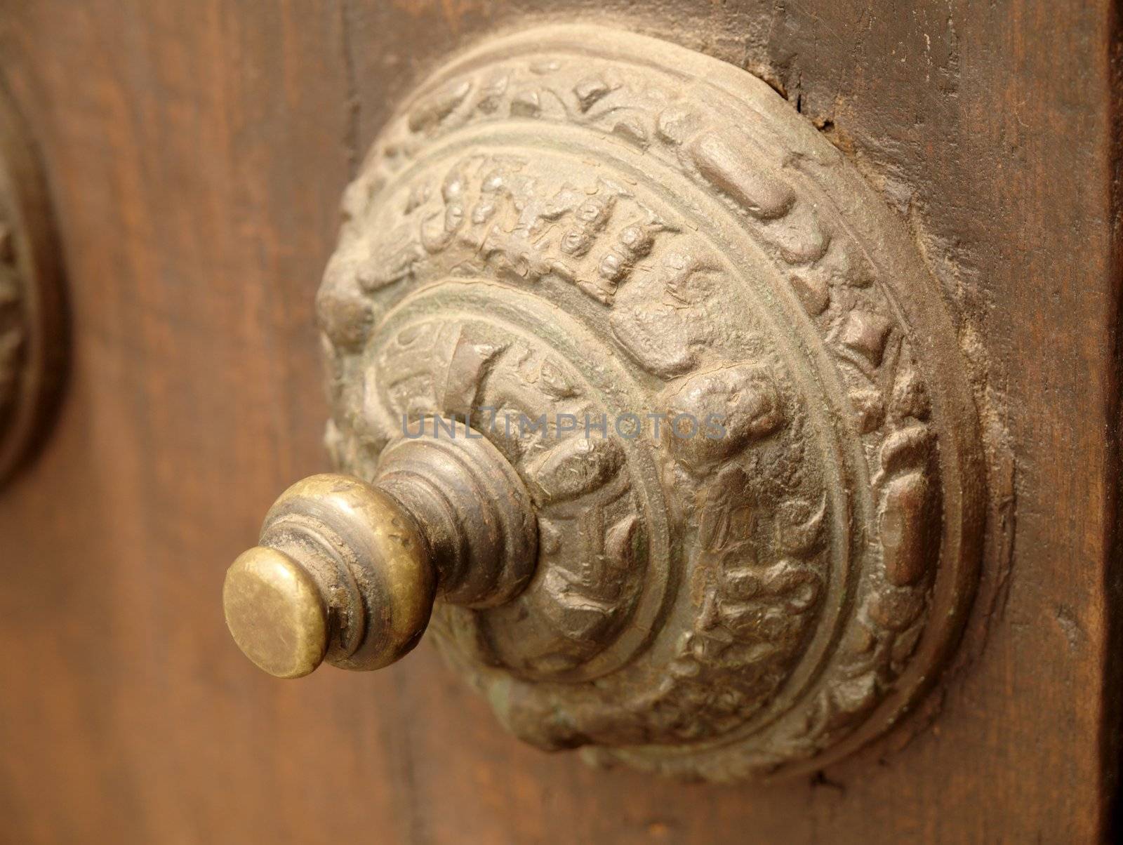 Old decorated door handle and the wooden door