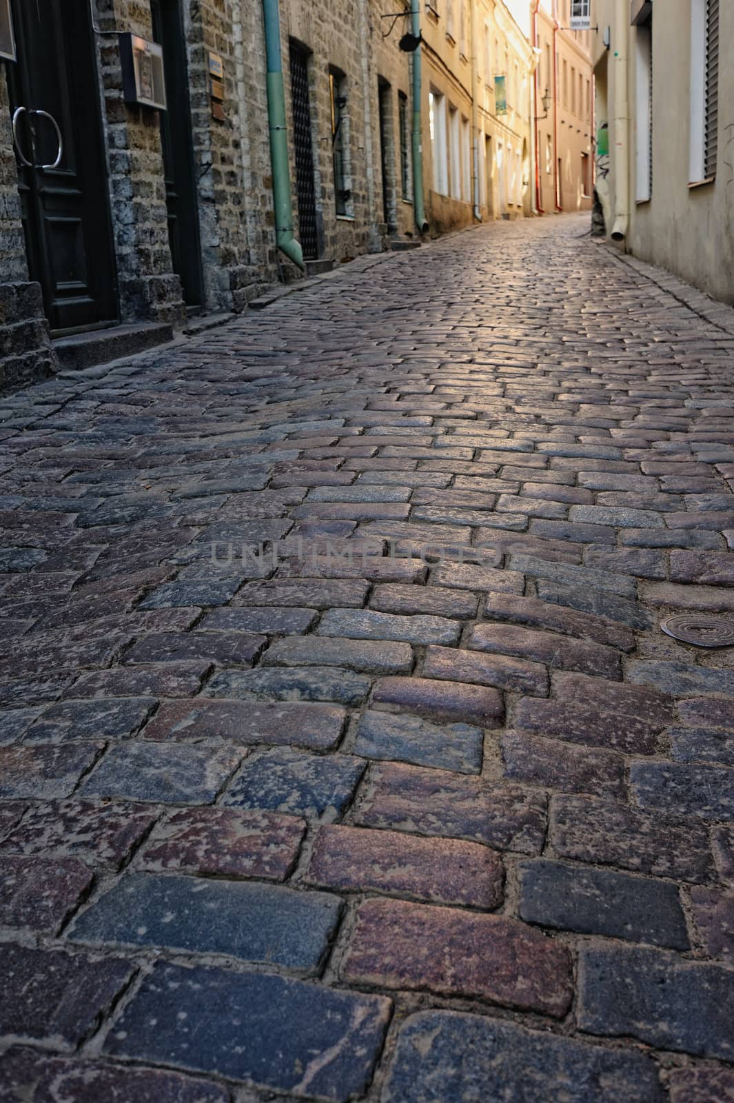 Сobblestone pavement in the narrow street in old town