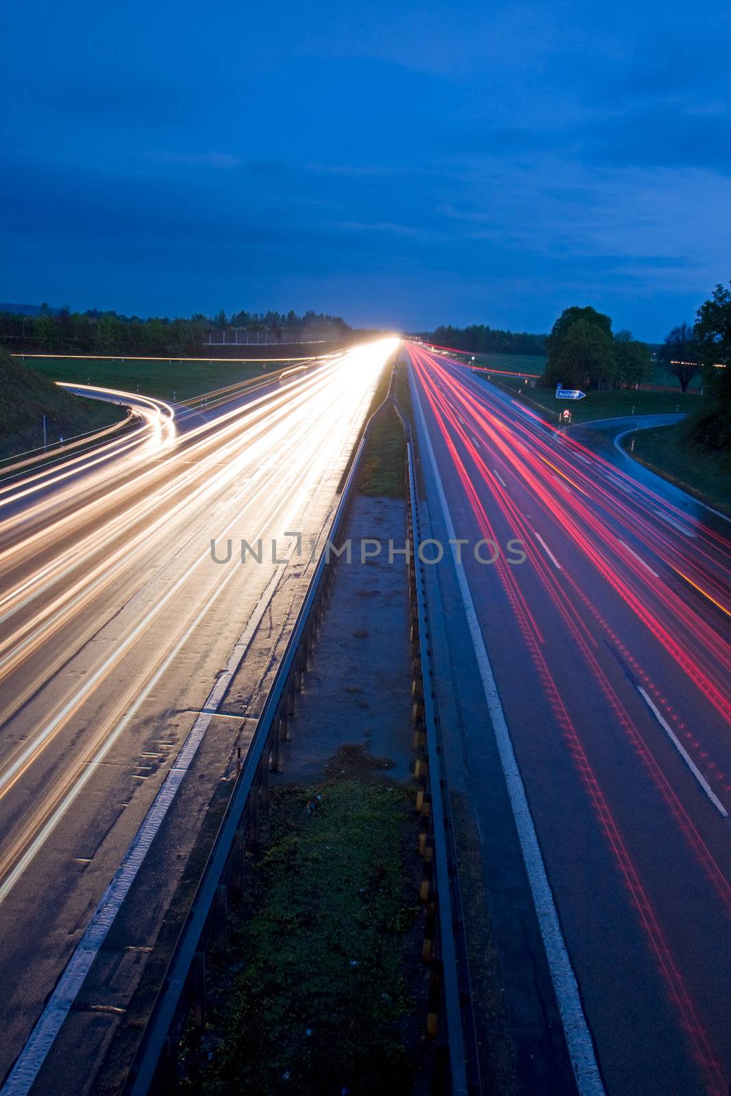 blurs of cars moving on a freeway by bernjuer