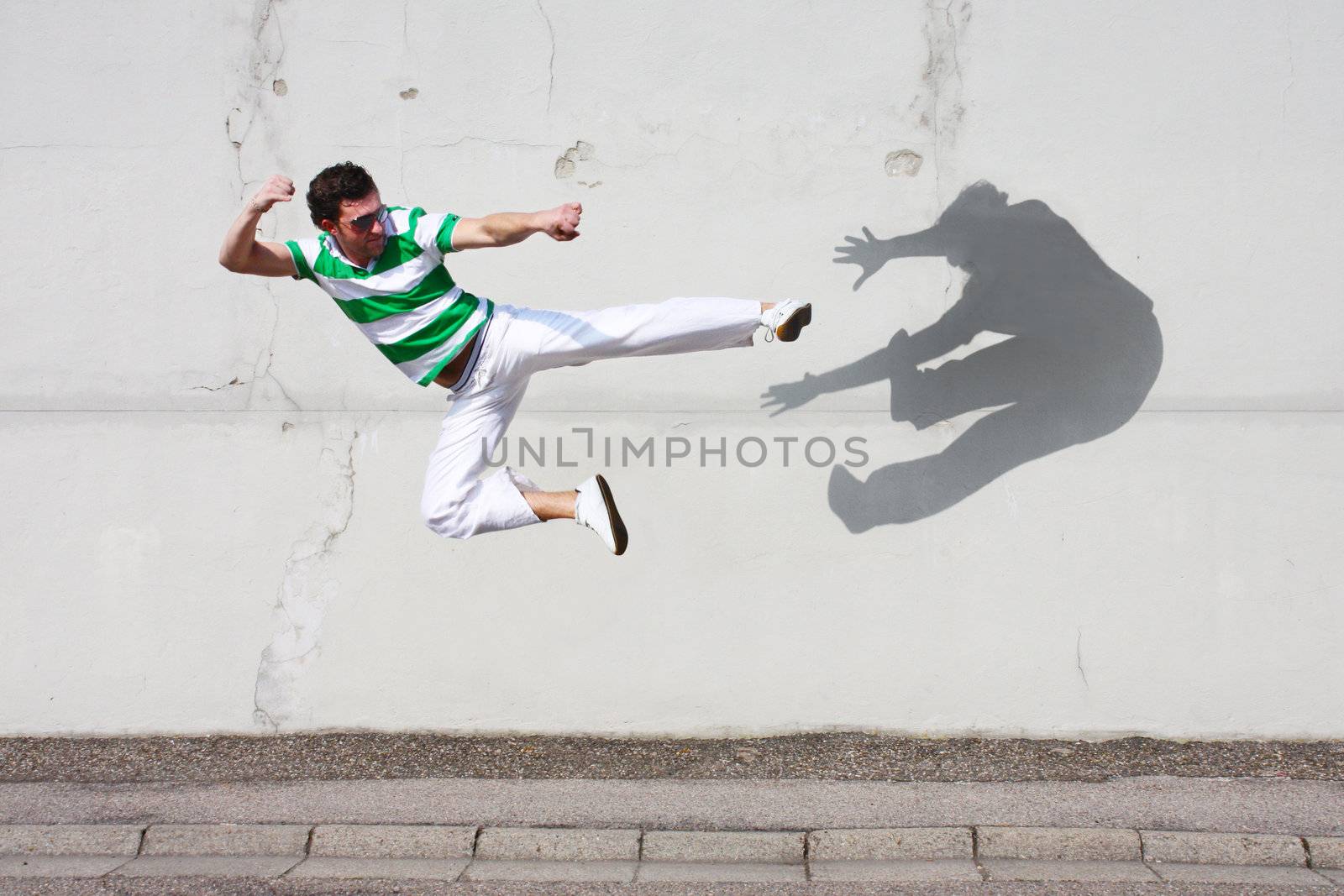 man fighting against his own shadow