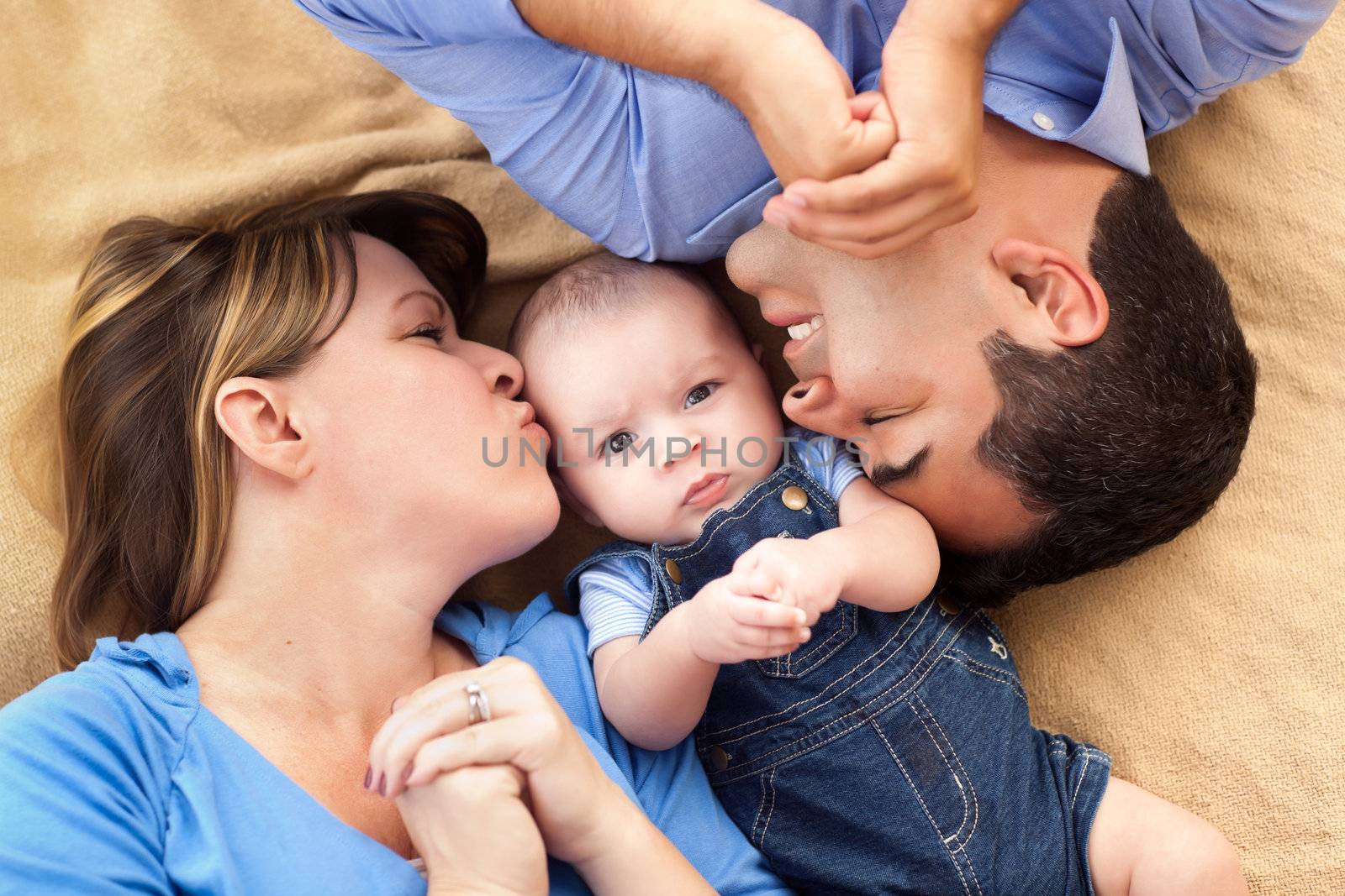 Mixed Race Family Playing Face Up on the Blanket.