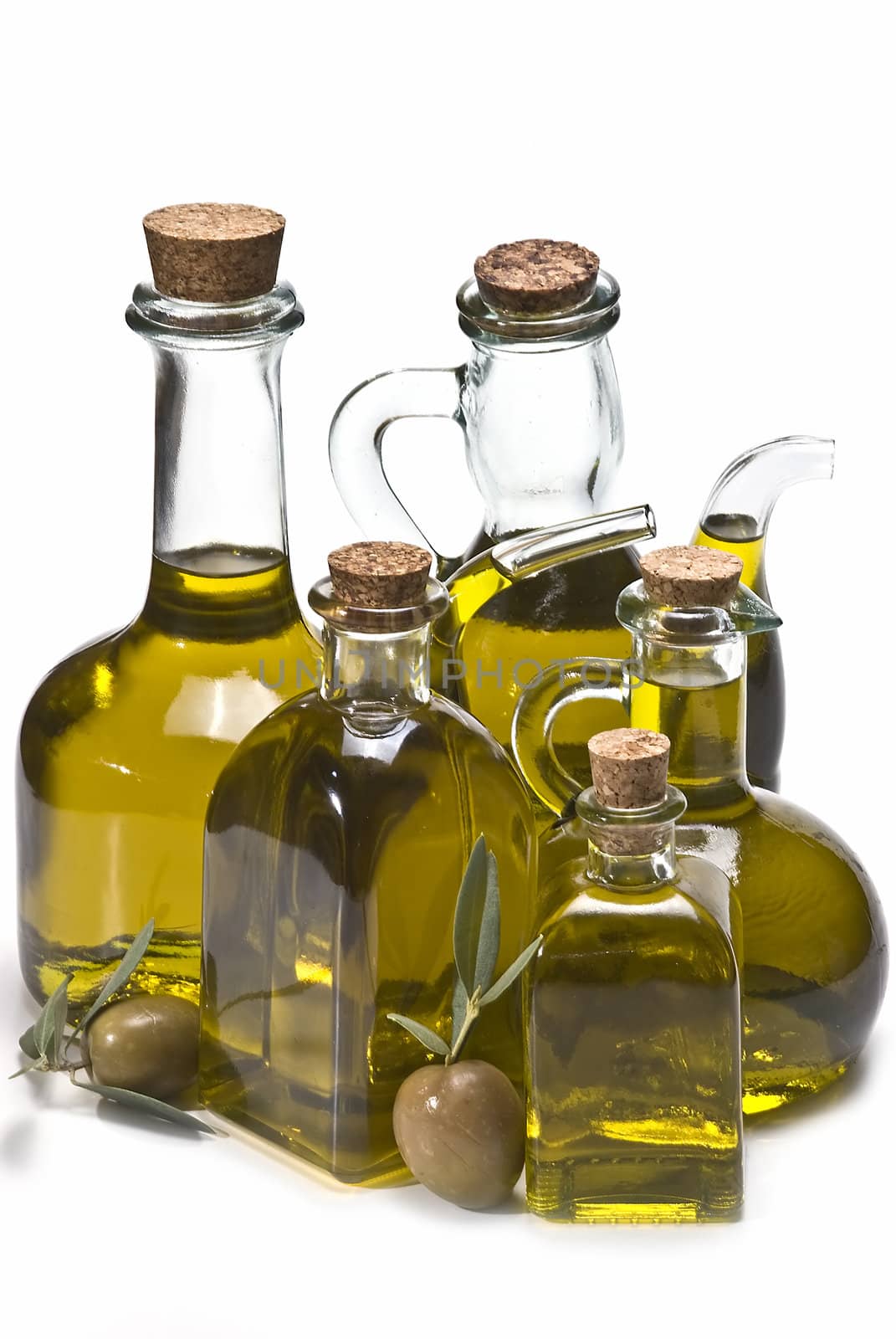 Olive oil bottles and olives isolated on a white background.