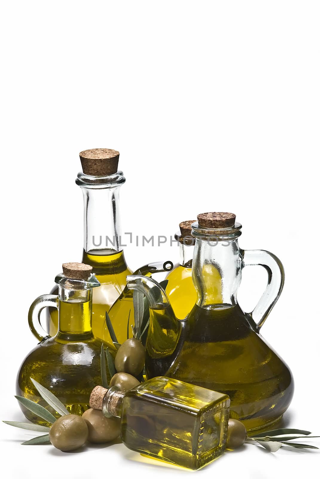 Olive oil bottles and olives isolated on a white background.