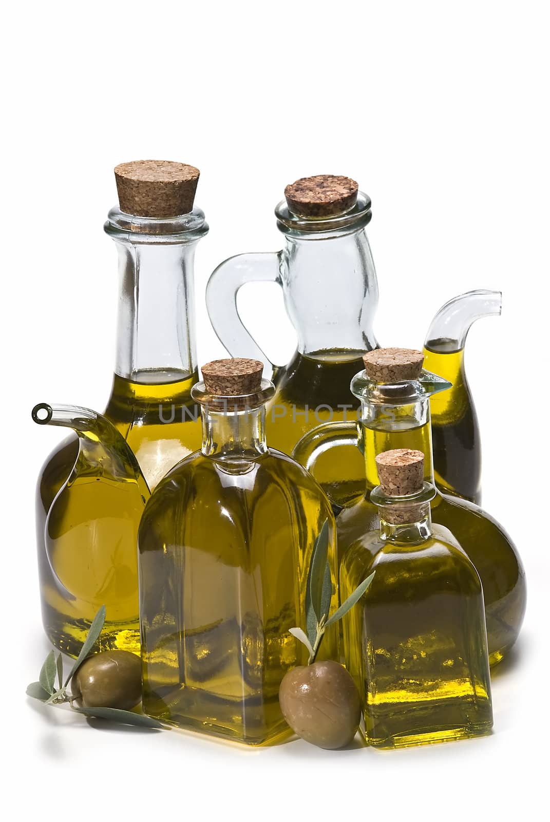 Olive oil bottles and olives isolated on a white background.