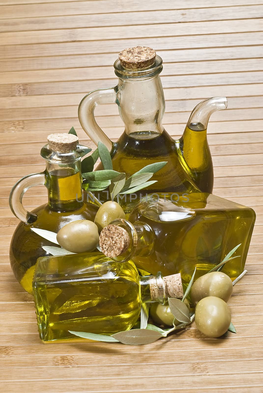 Olive oil bottles on a bamboo mat.