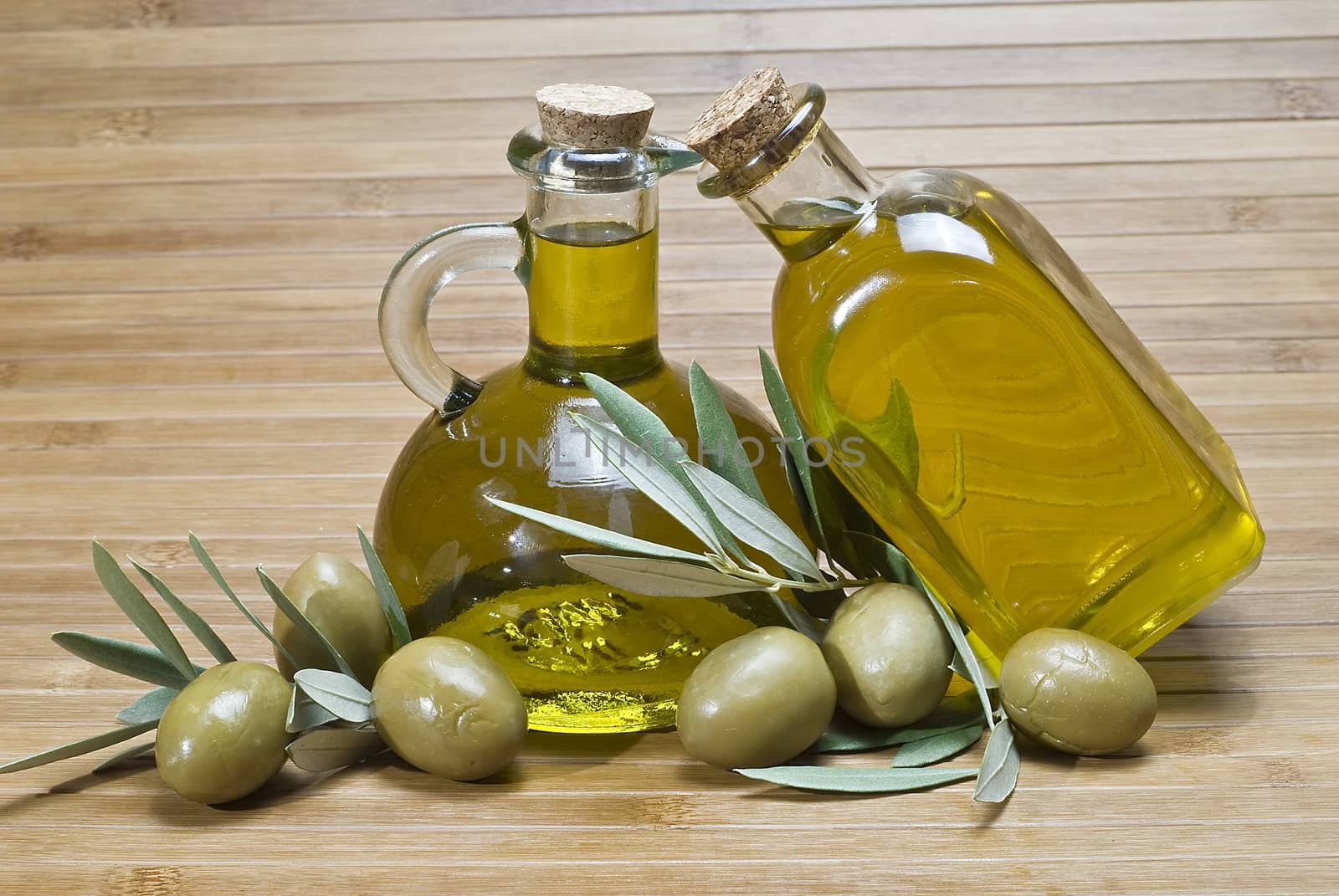 Olive oil bottles on a bamboo mat.