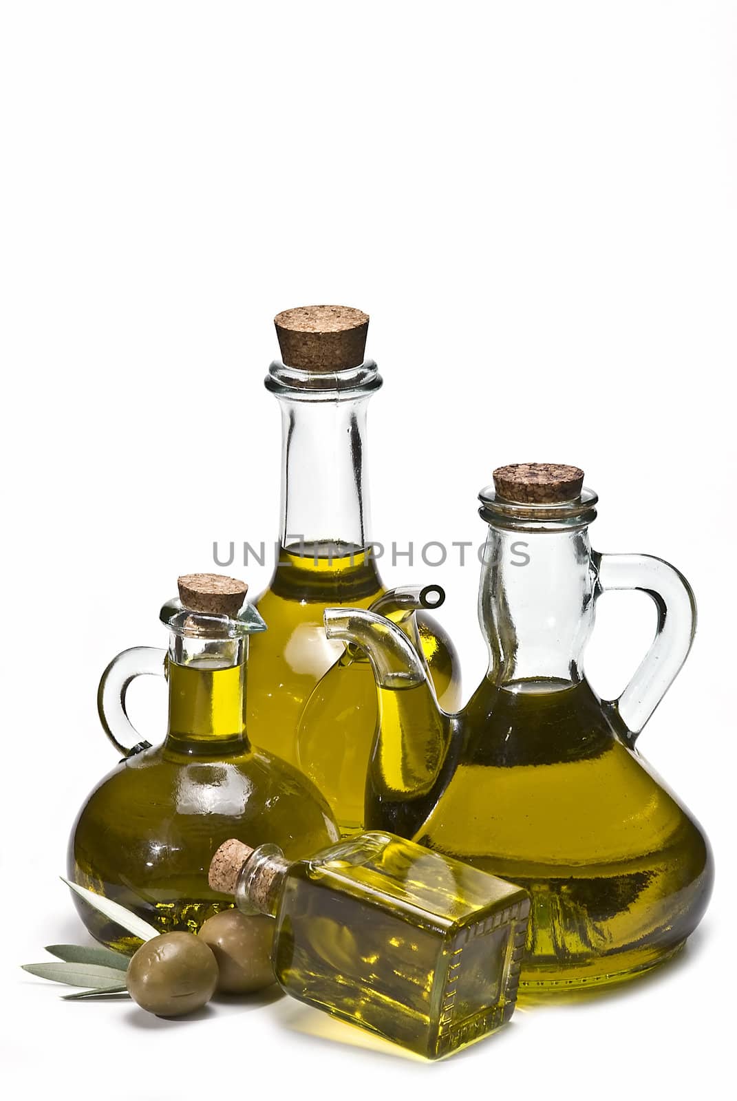 Olive oil bottles and olives isolated on a white background.