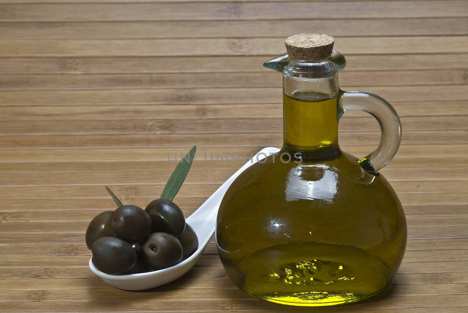 Olive oil bottles on a bamboo mat.