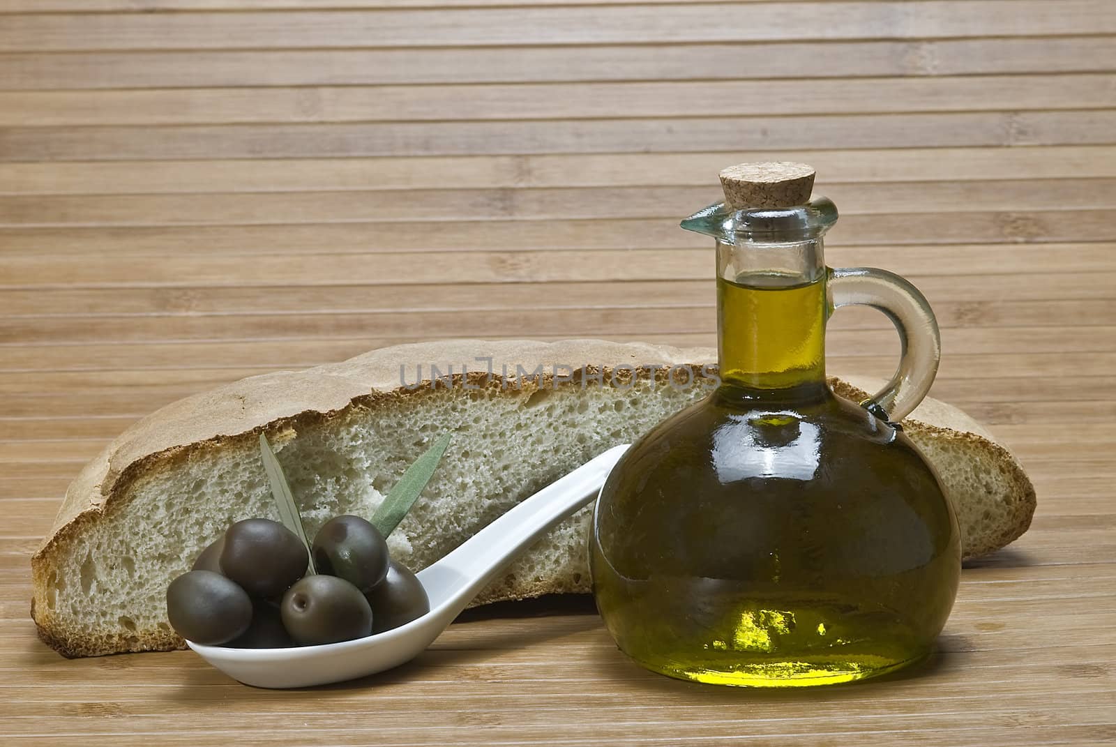 Olive oil bottles on a bamboo mat.